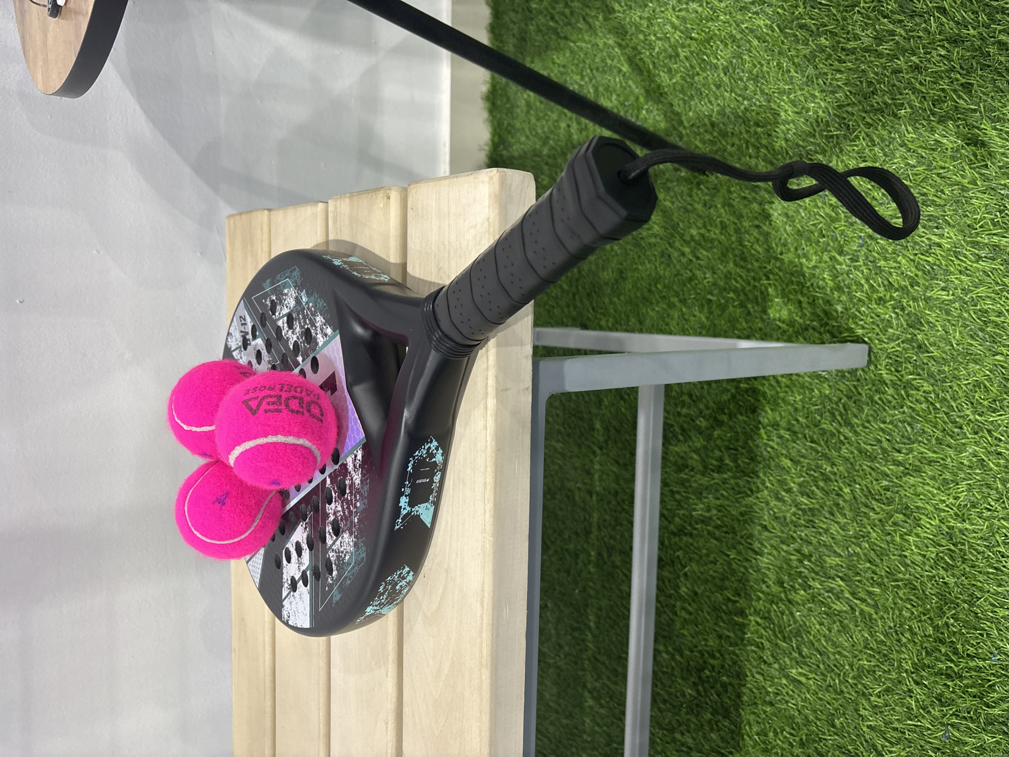 Padel gear laid out on a blue court in Chaikovsky