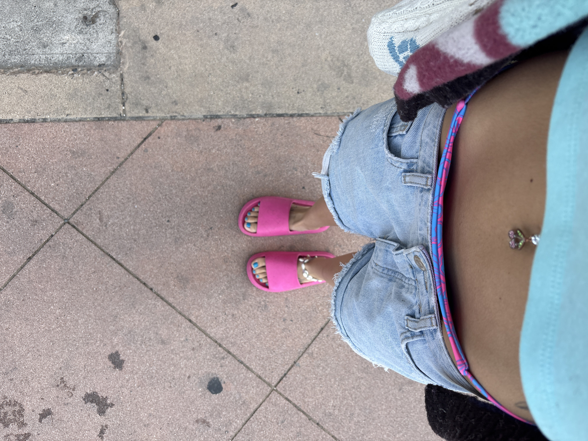 Person in swimwear walks through Huntington Beach streets