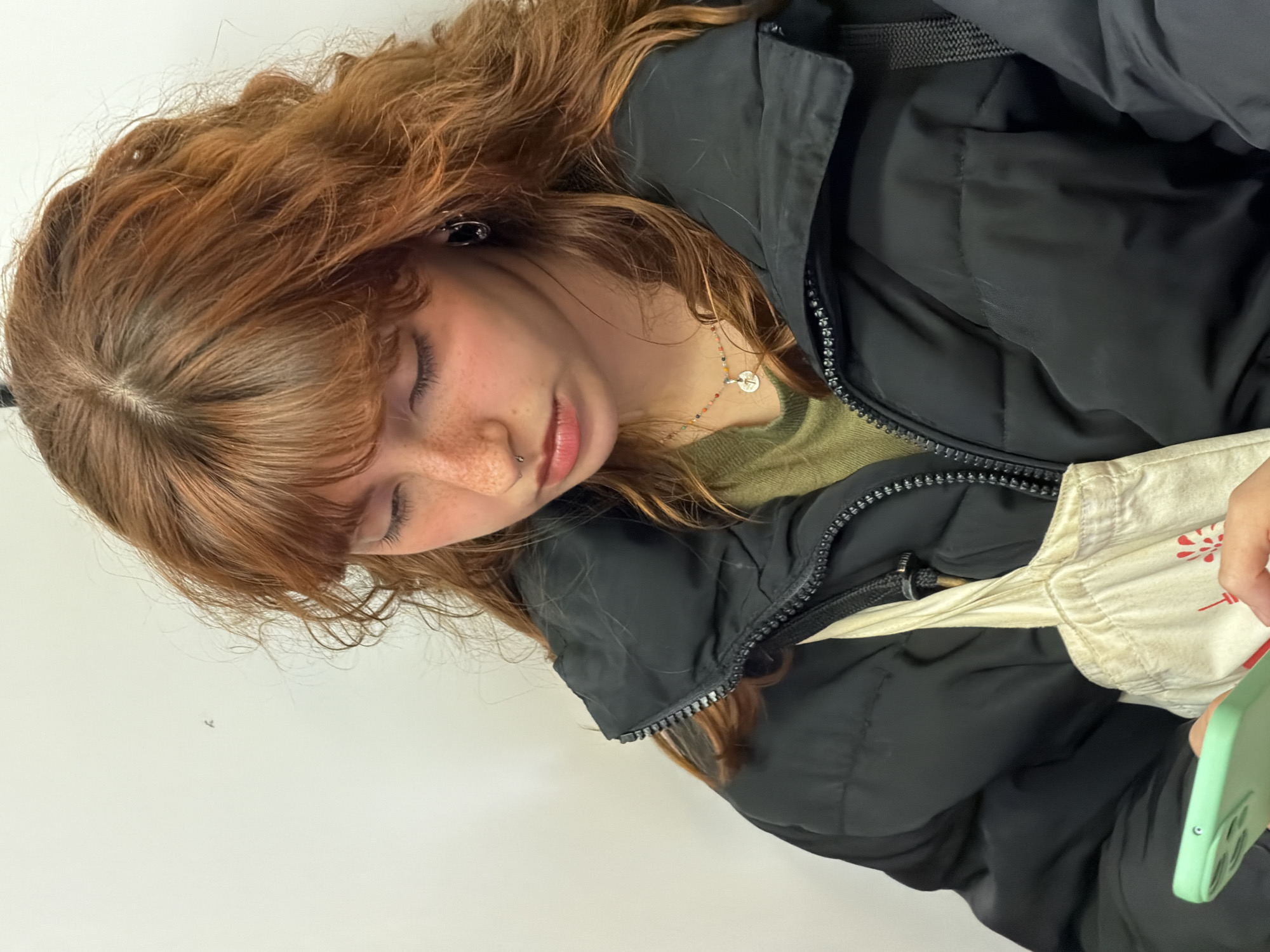 Young woman with phone spotted resting in Madrid