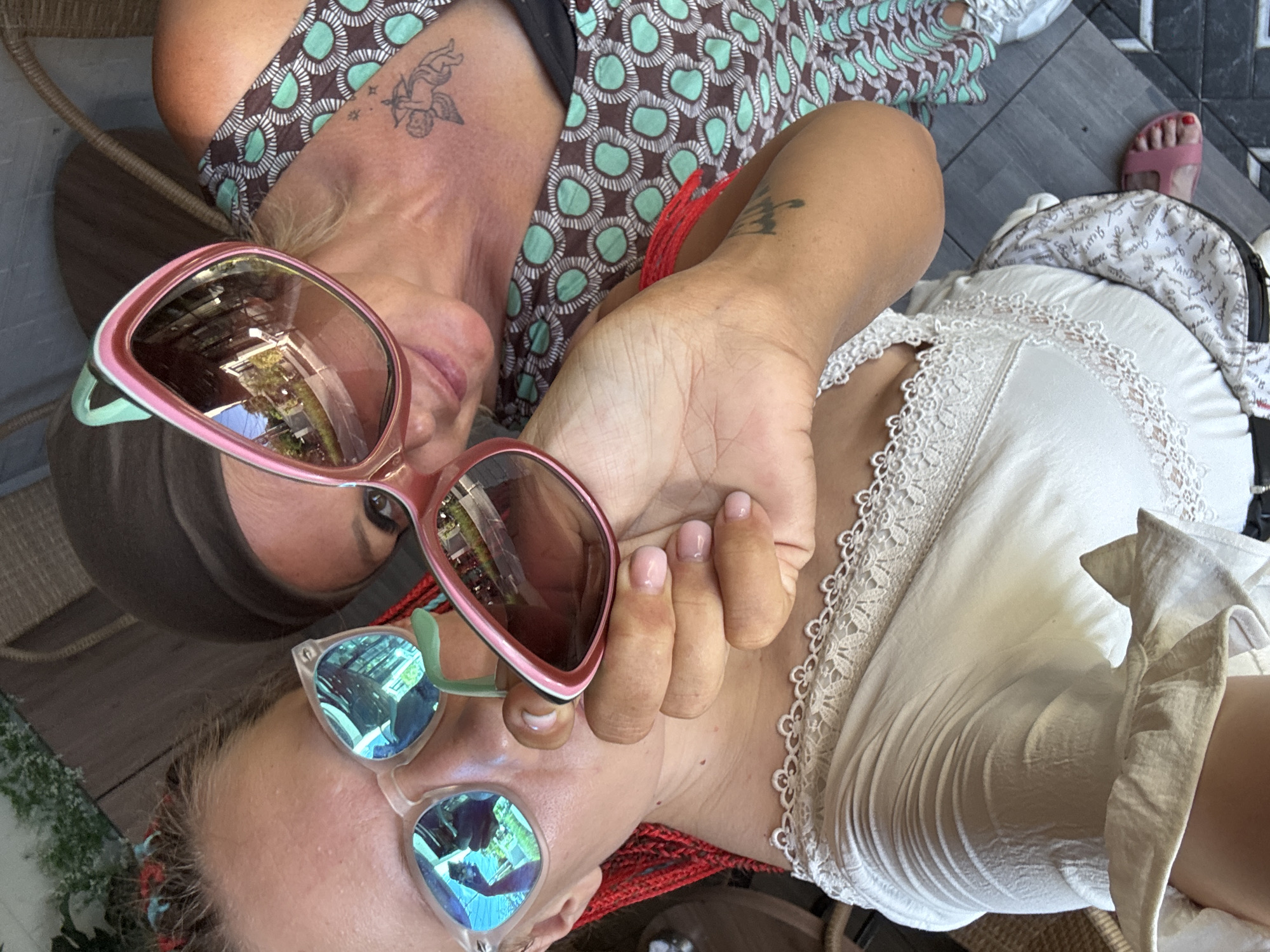 Two women relax at modern Kuta cafe
