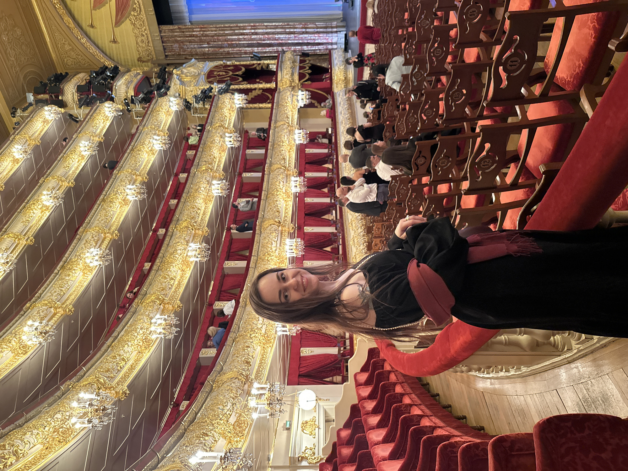 Woman photographed smiling in ornate Moscow theater interior