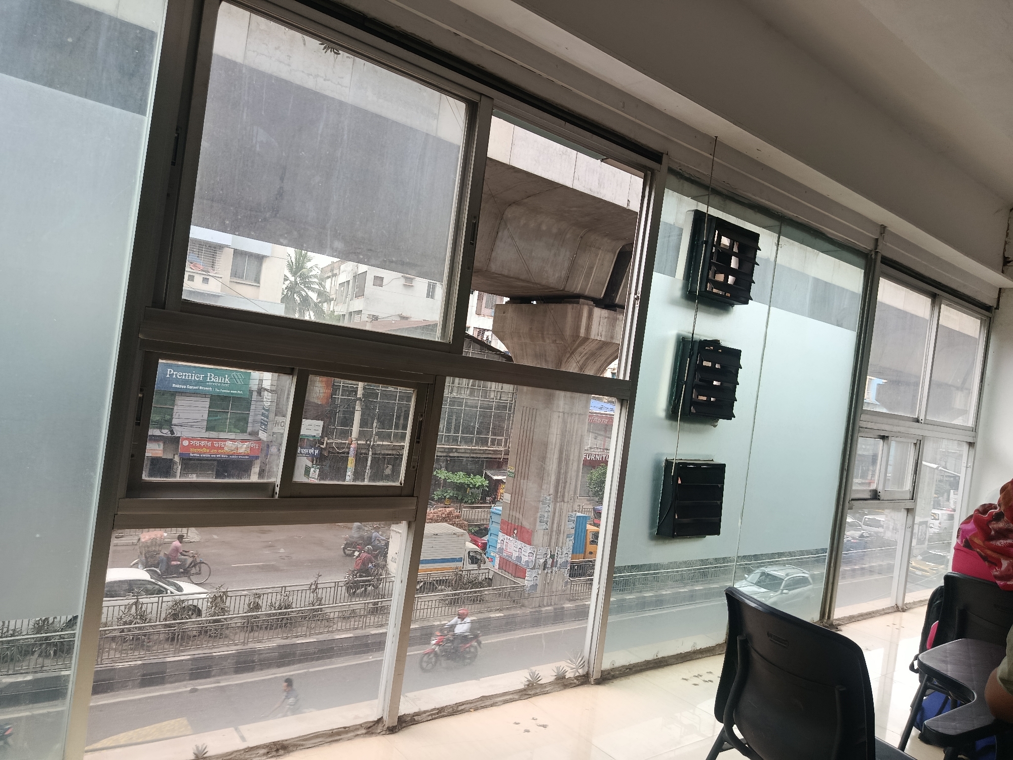 Indoor workshop session in Dhaka with street views outside