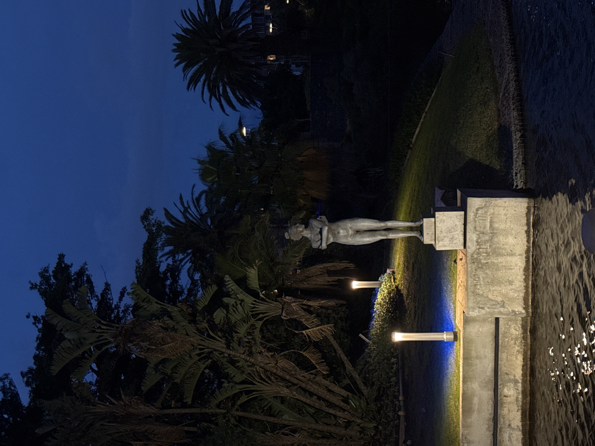 Illuminated nude statue observed near water in Milnerton