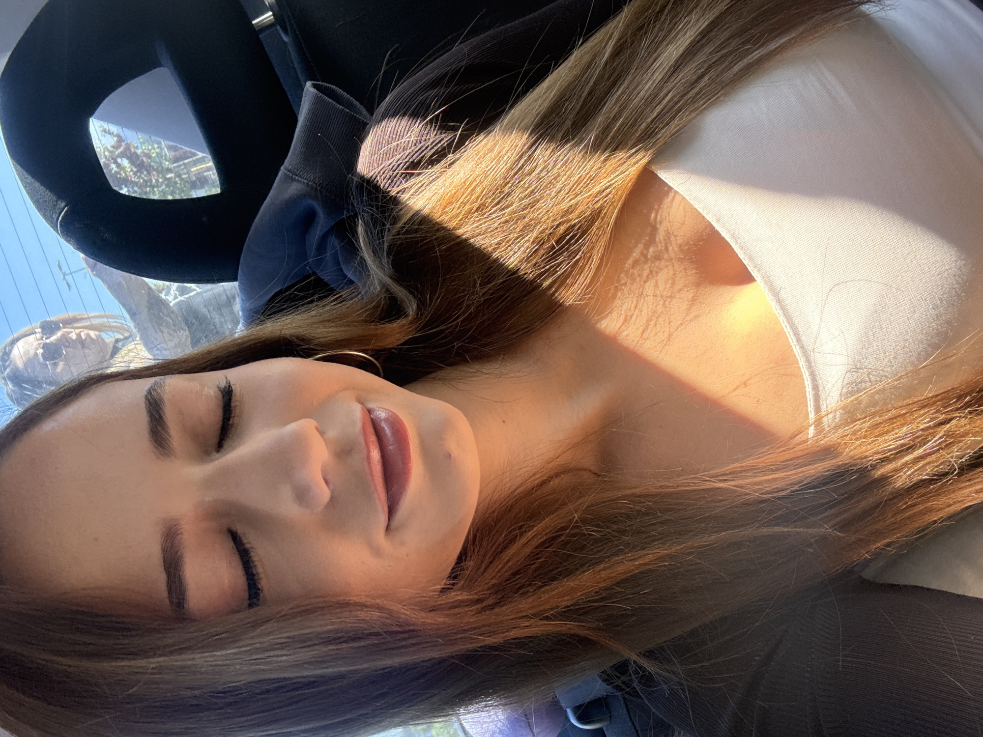 Woman rests in car during morning hours in Pernik