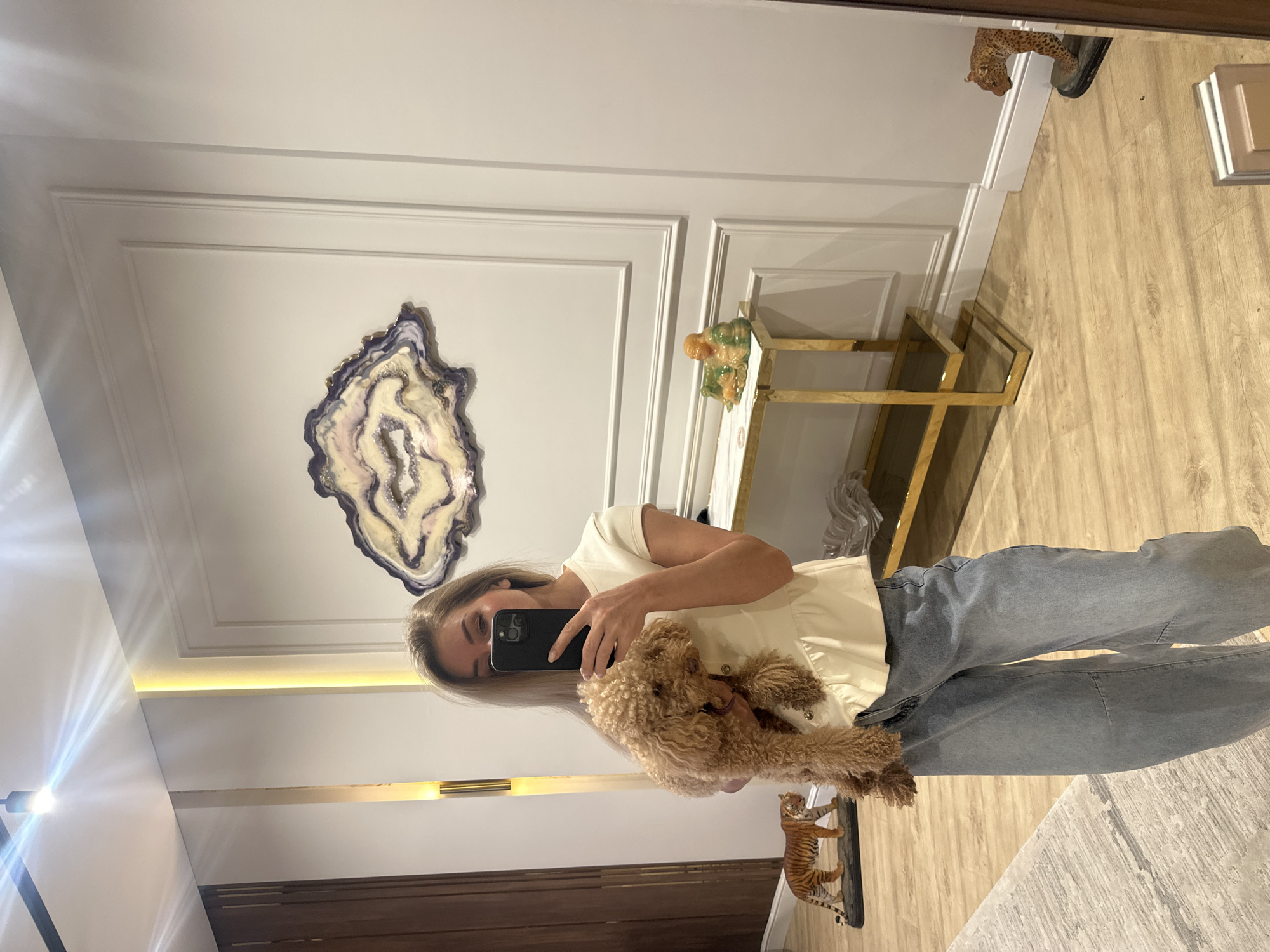 Woman takes mirror selfies with poodle in Armavir home