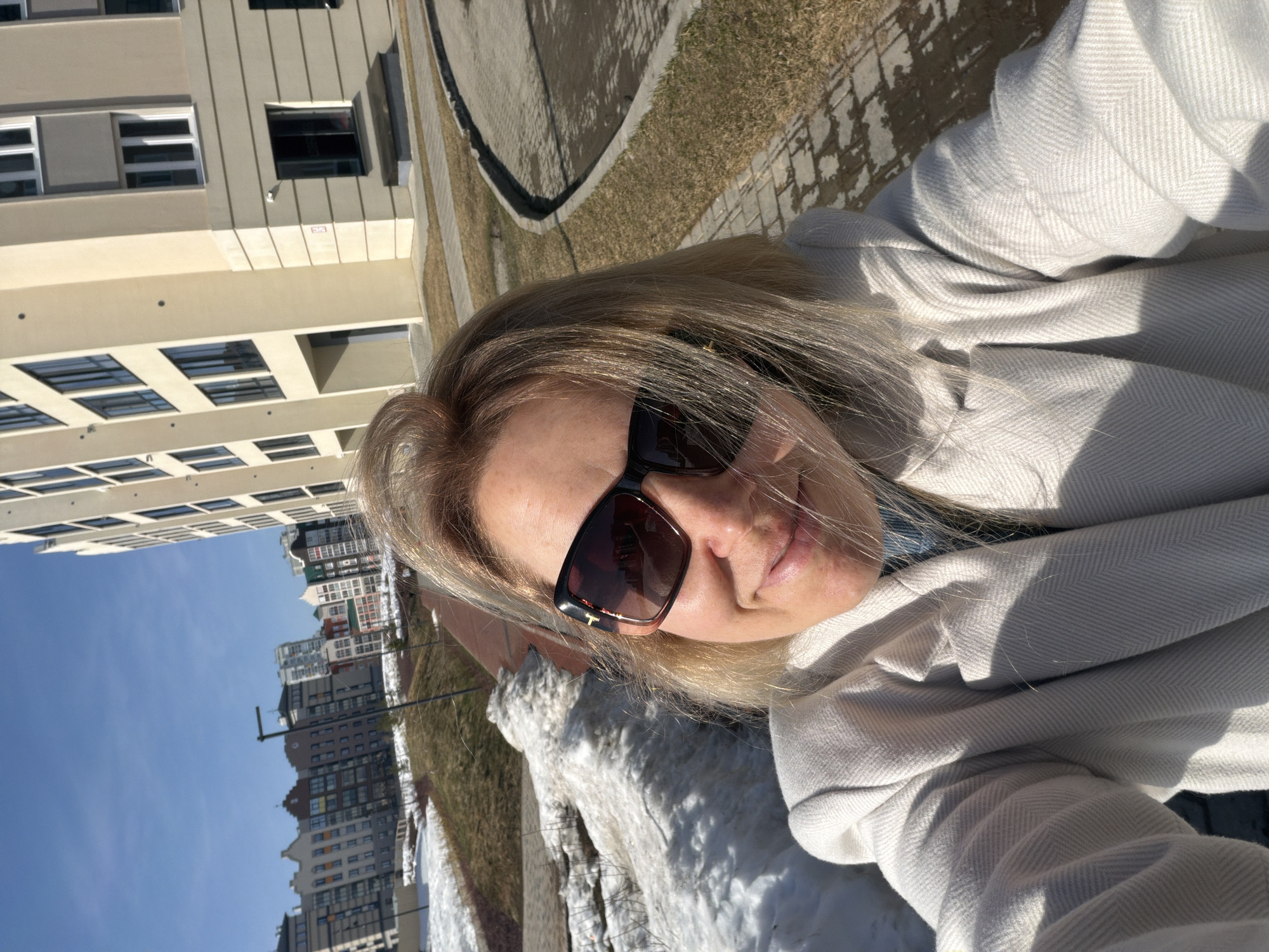 Woman takes selfies on street in Pervomaysky, Russia