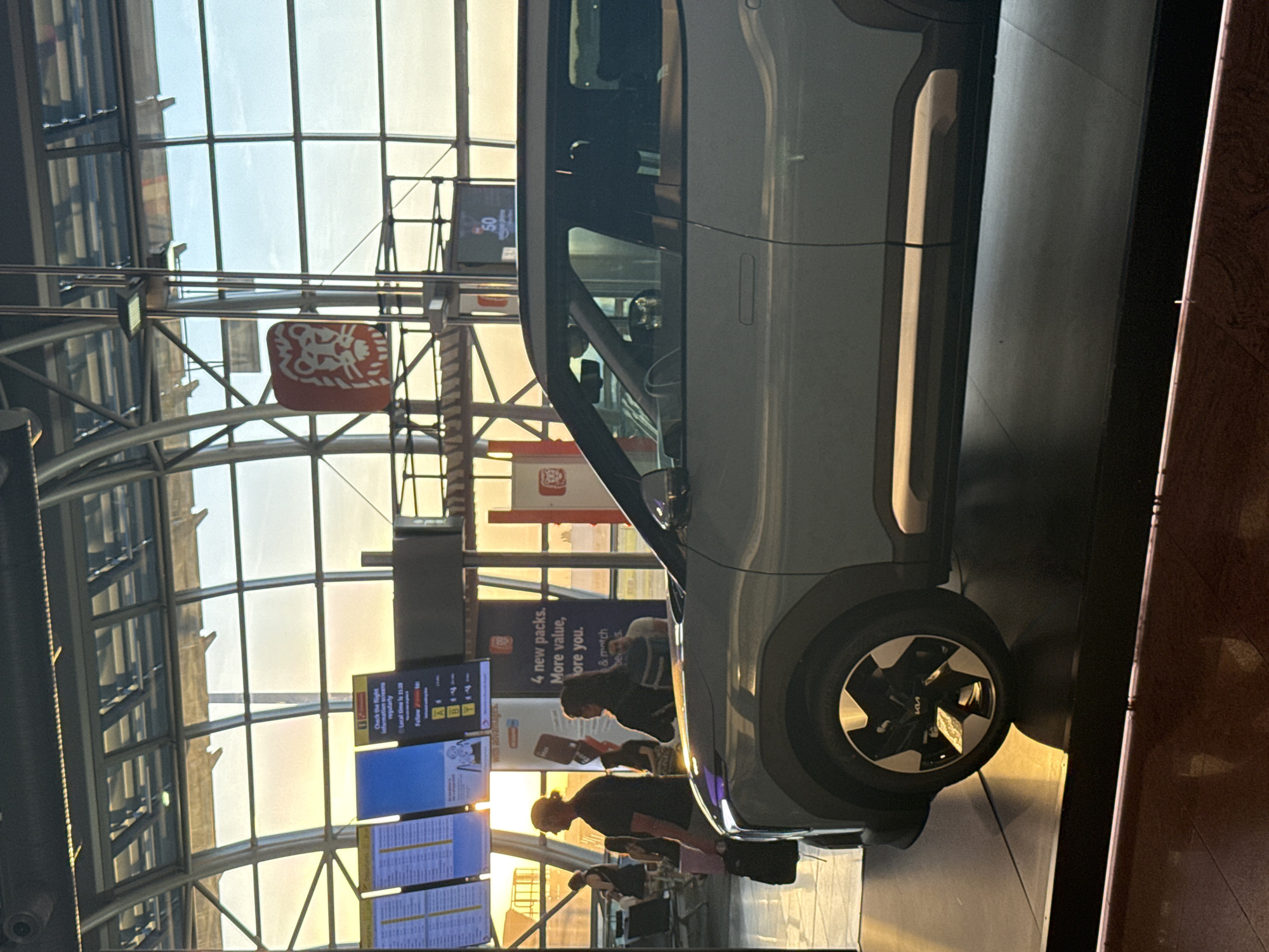 Kia EV6 on display at Brussels Airport terminal at sunset