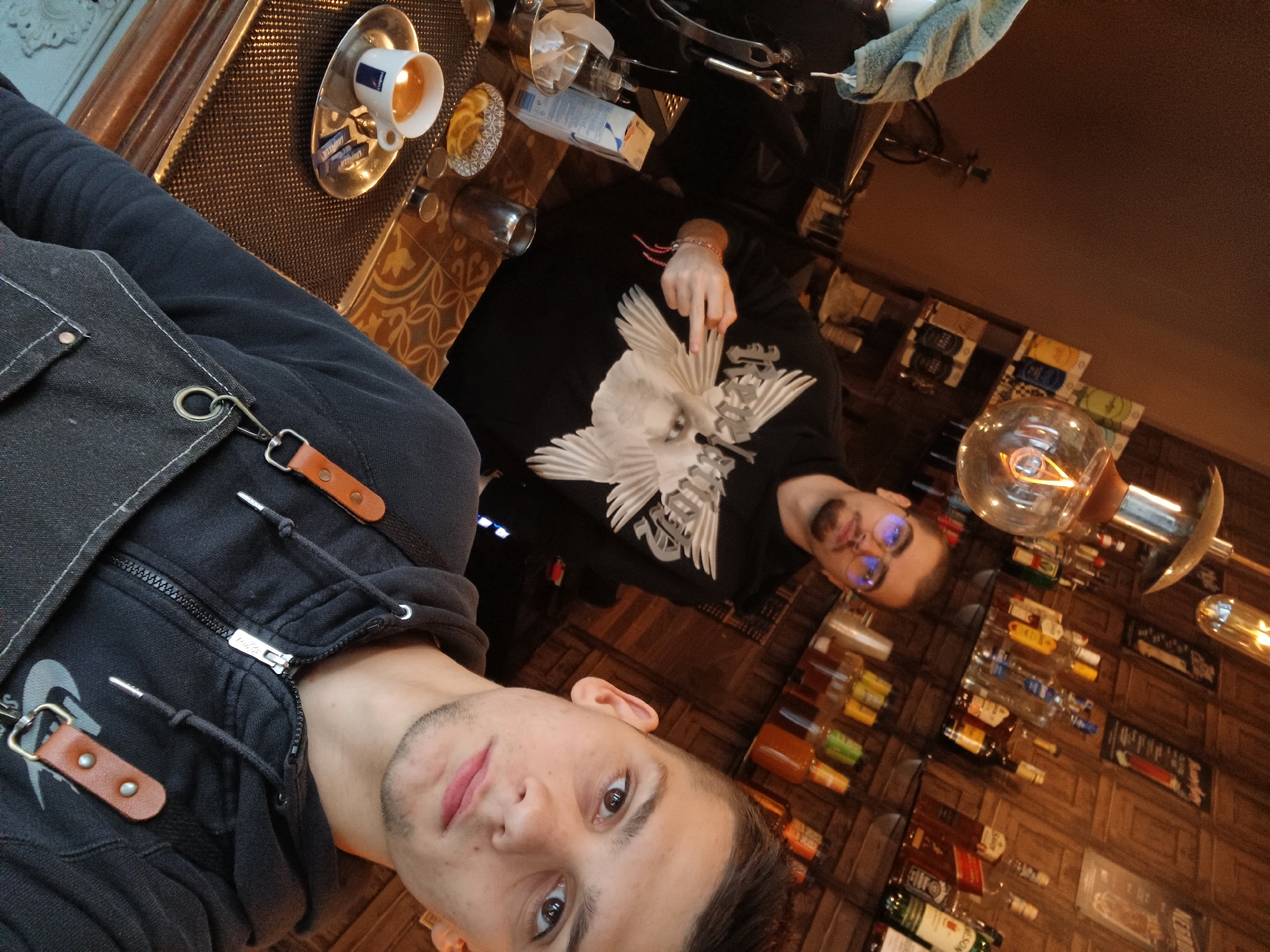 Two men photographed together at bar or café