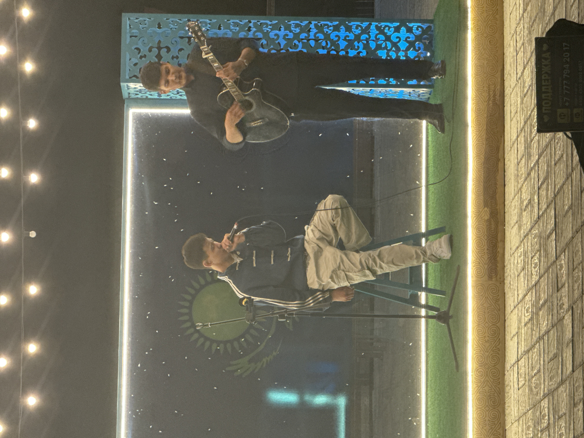 Outdoor stage performance in Pavlodar under Kazakh flag imagery