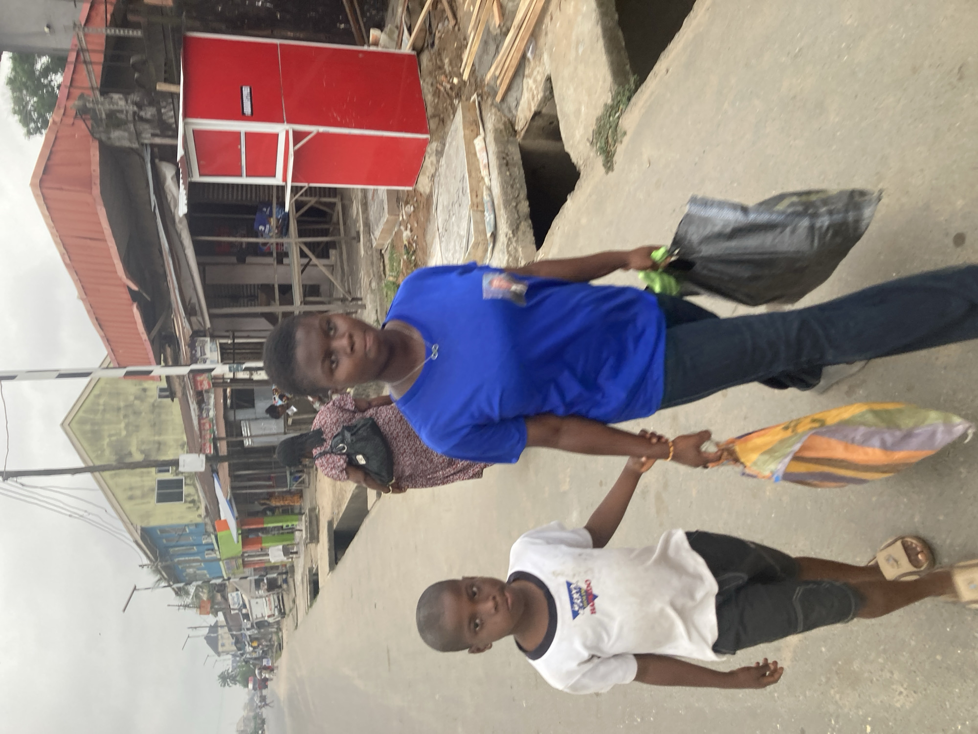 Ordinary street life documented across Aba, Nigeria during overcast afternoon