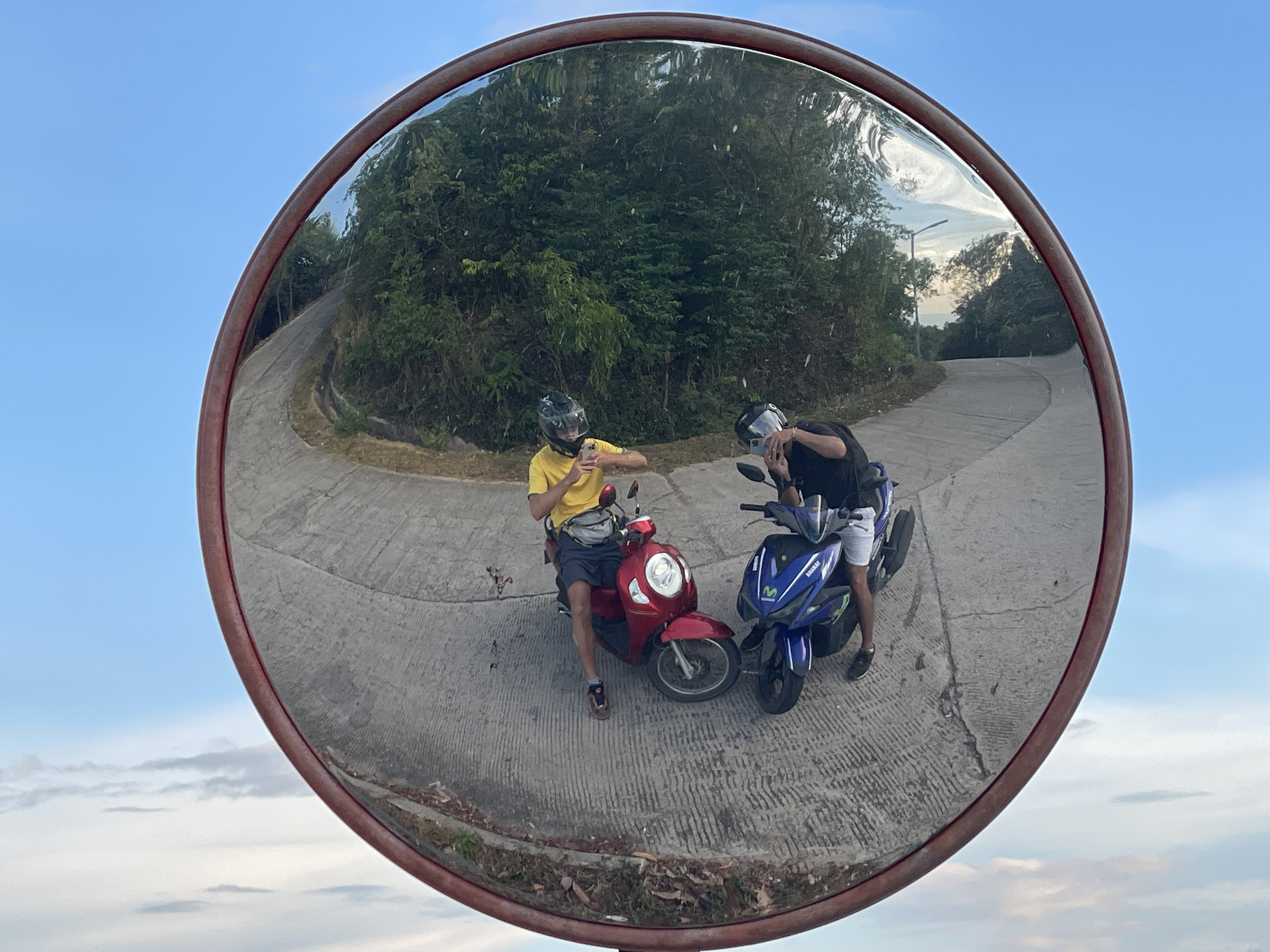 Two motorcyclists meet on rural Thai road