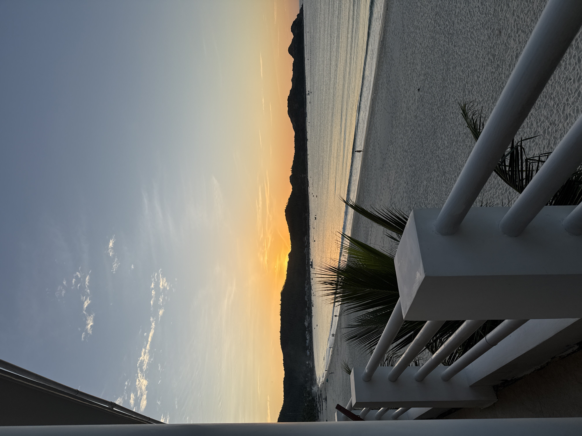 Balcony and beach views of a quiet sunset