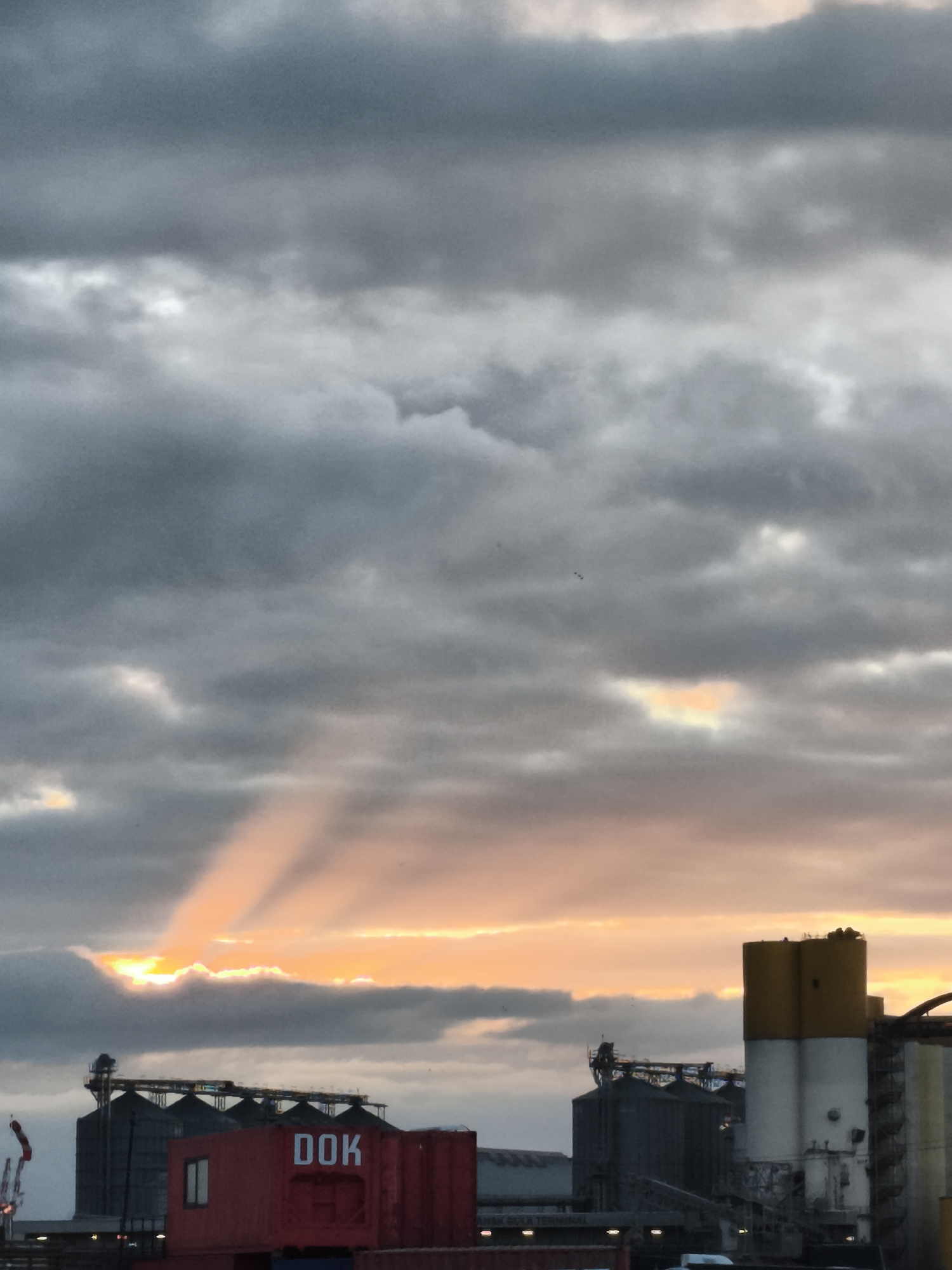 Dusk walk around Gdańsk's port, sunset breaking through storm clouds.