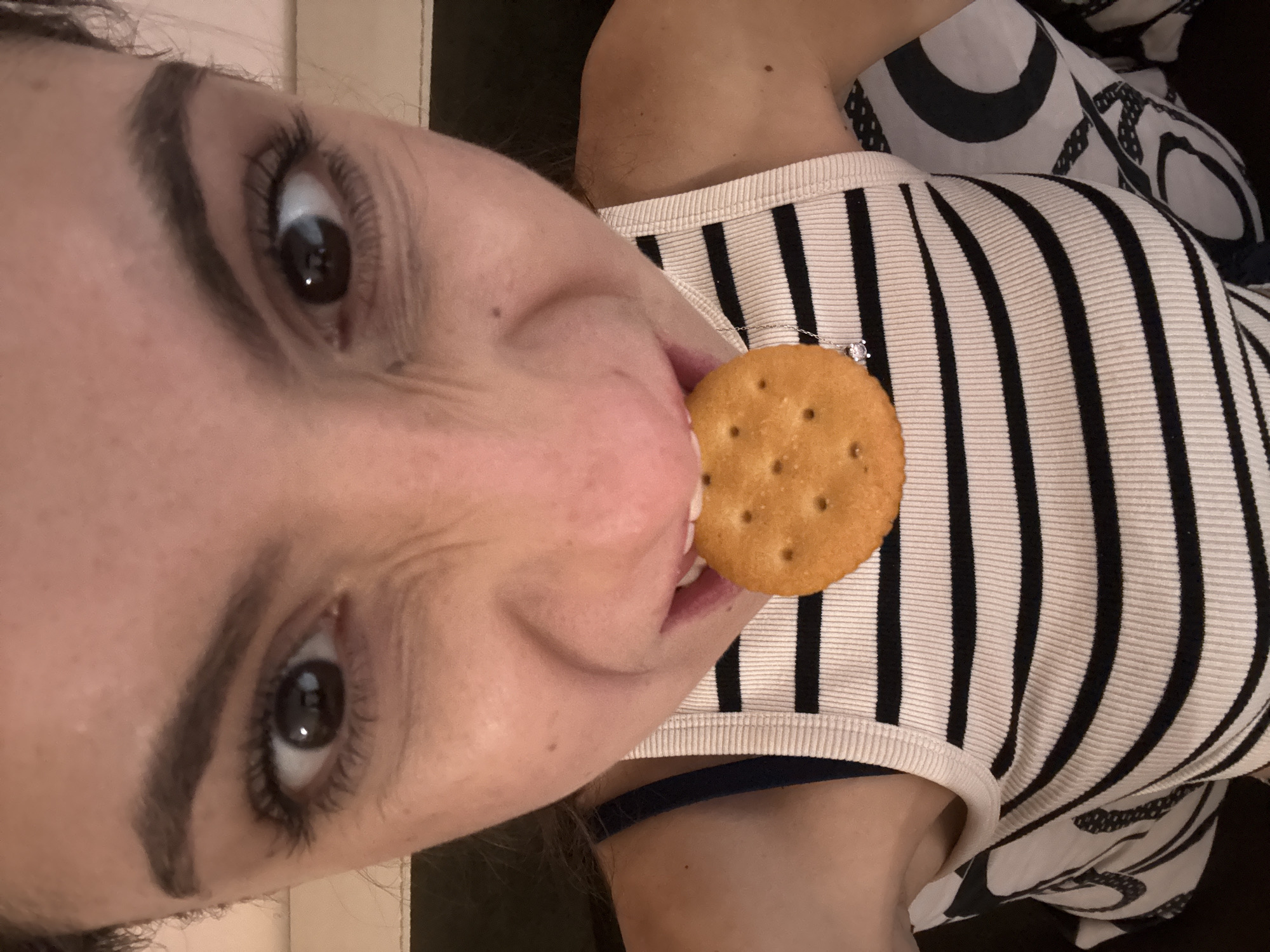 Woman eating cracker captured in casual moment in Varna