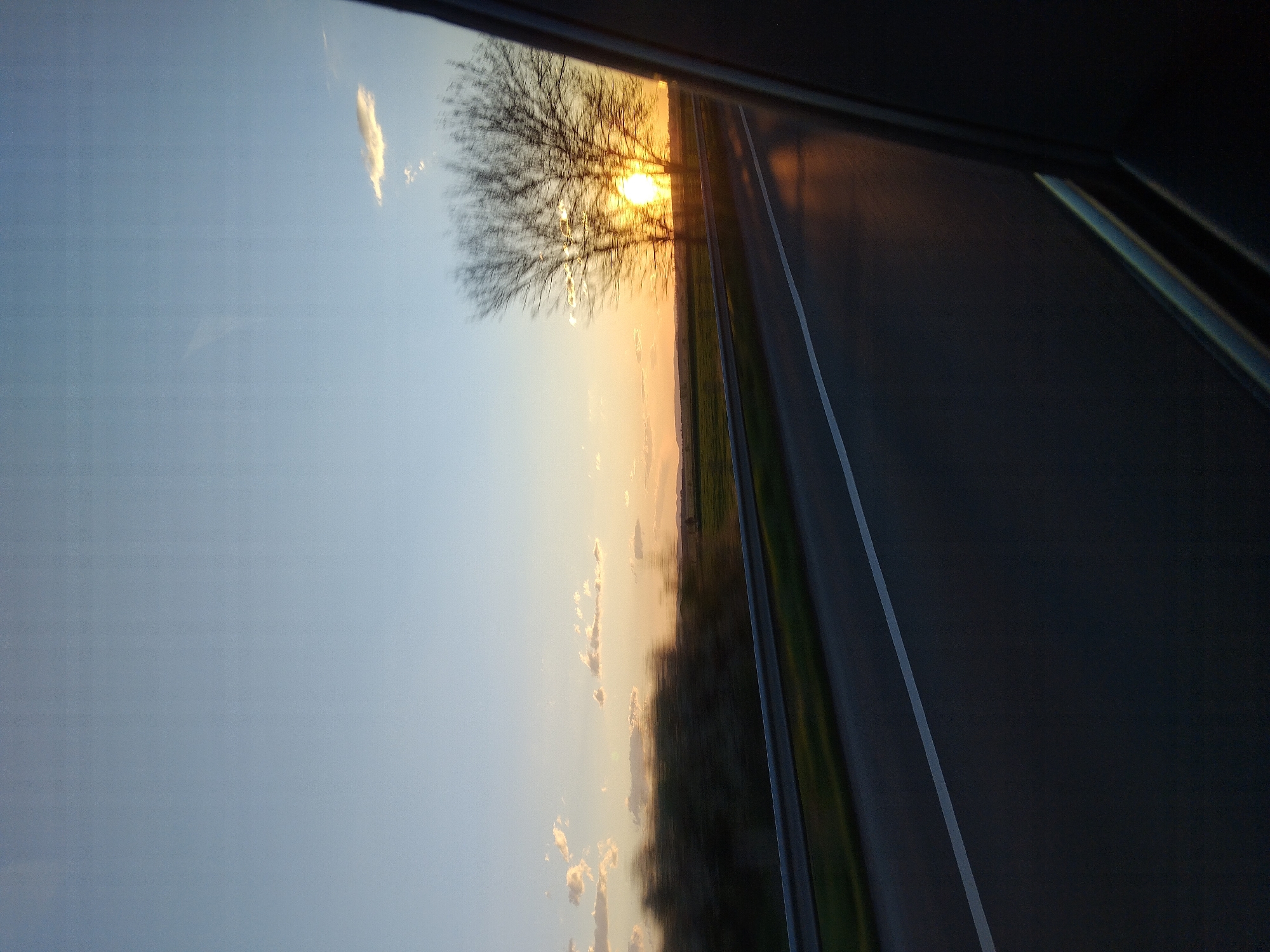 Sunset rural landscape viewed from car window in Belozem