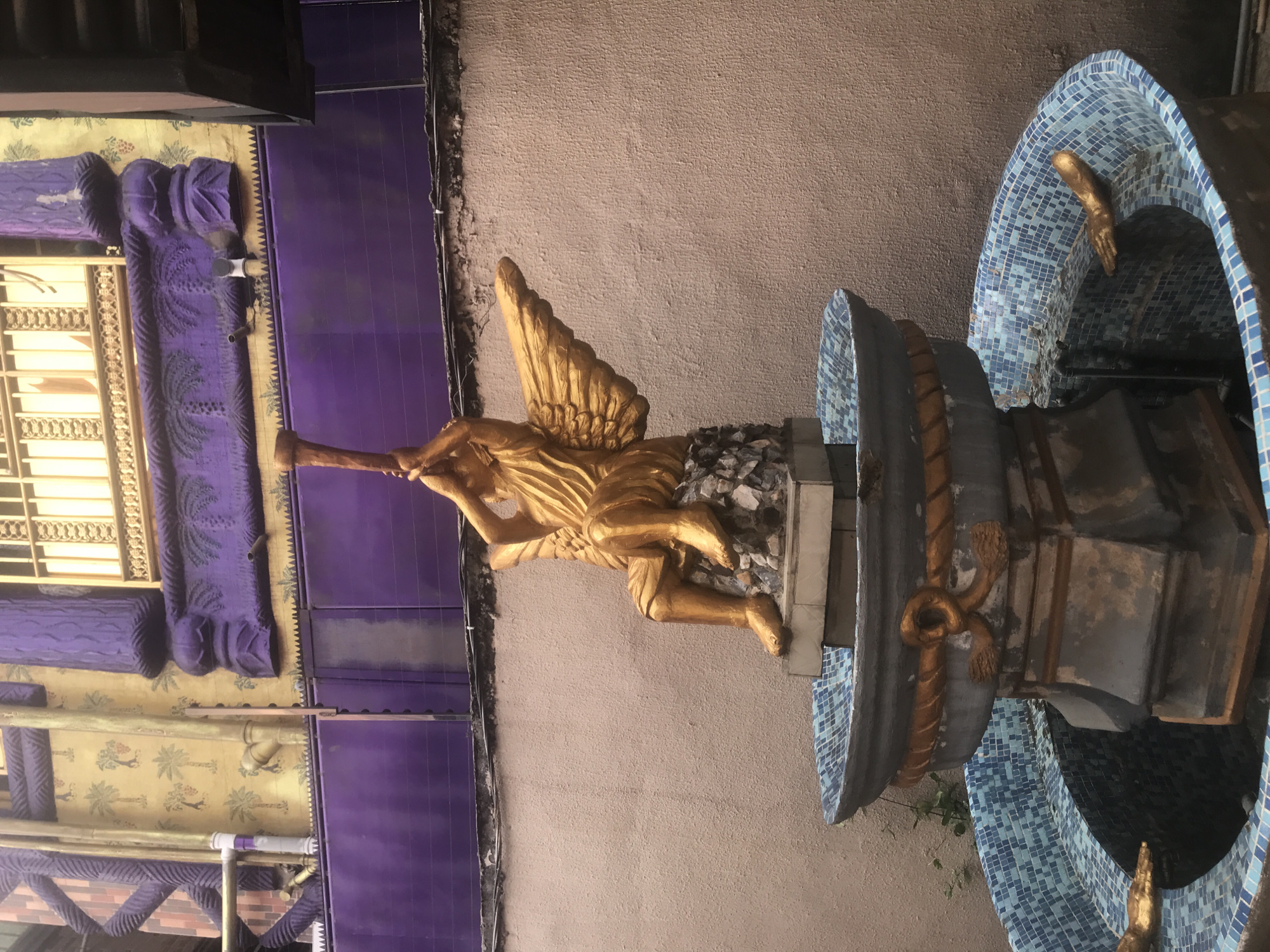 Ornate religious complex with golden angel fountain documented in Onitsha