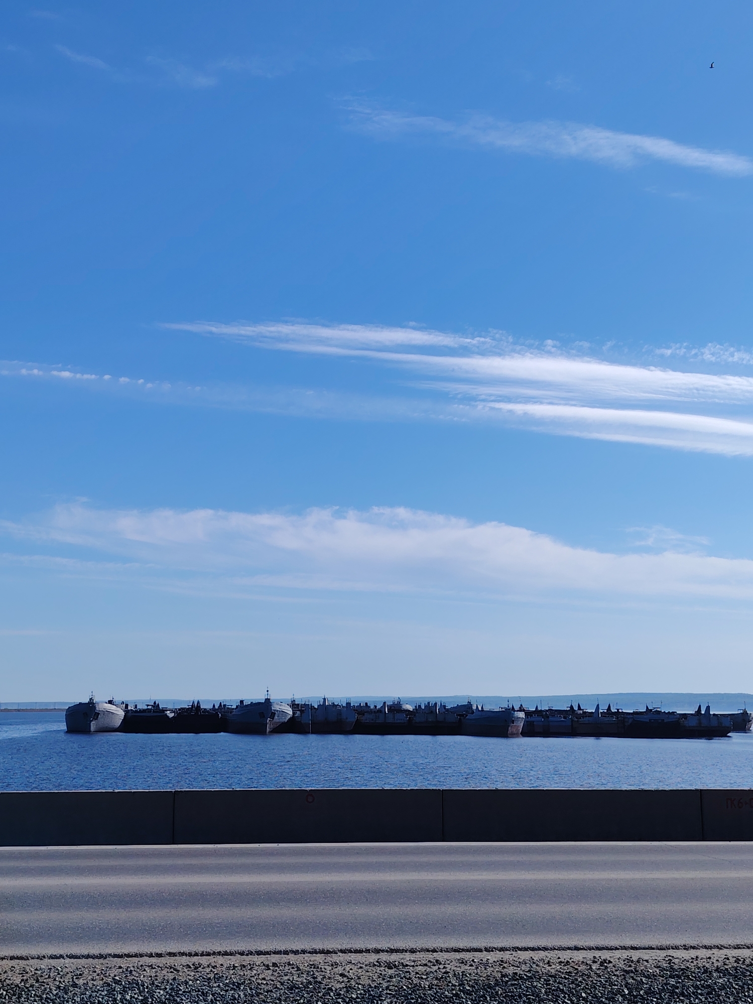 Ships anchored in Russian reservoir, cyclists observed nearby