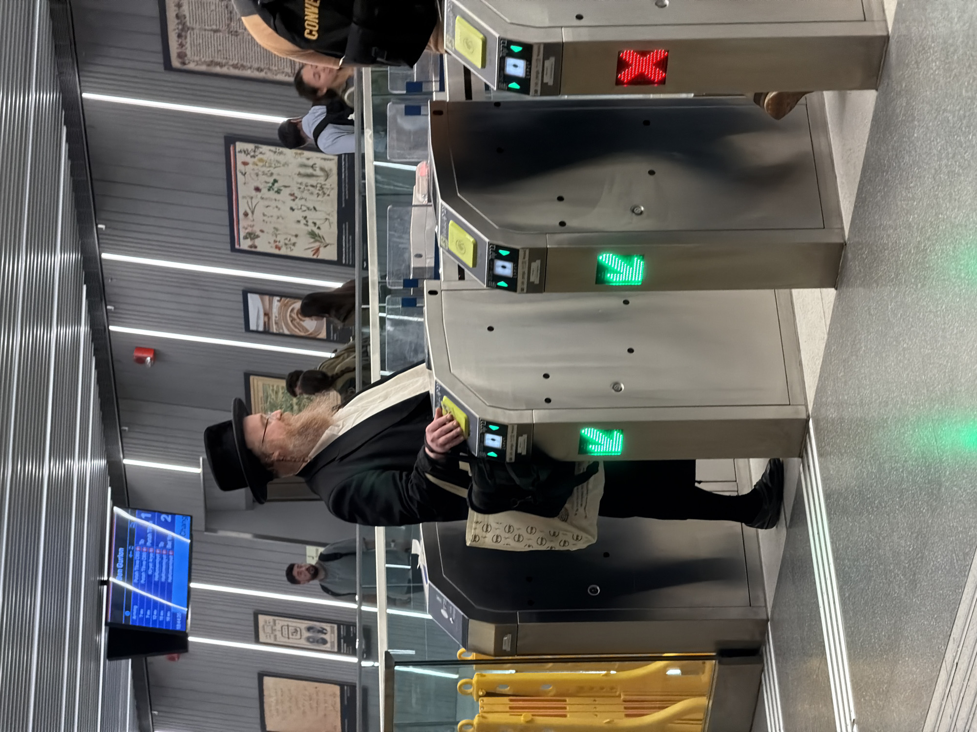 Rush of commuters through Bnei Brak's turnstile-gated station