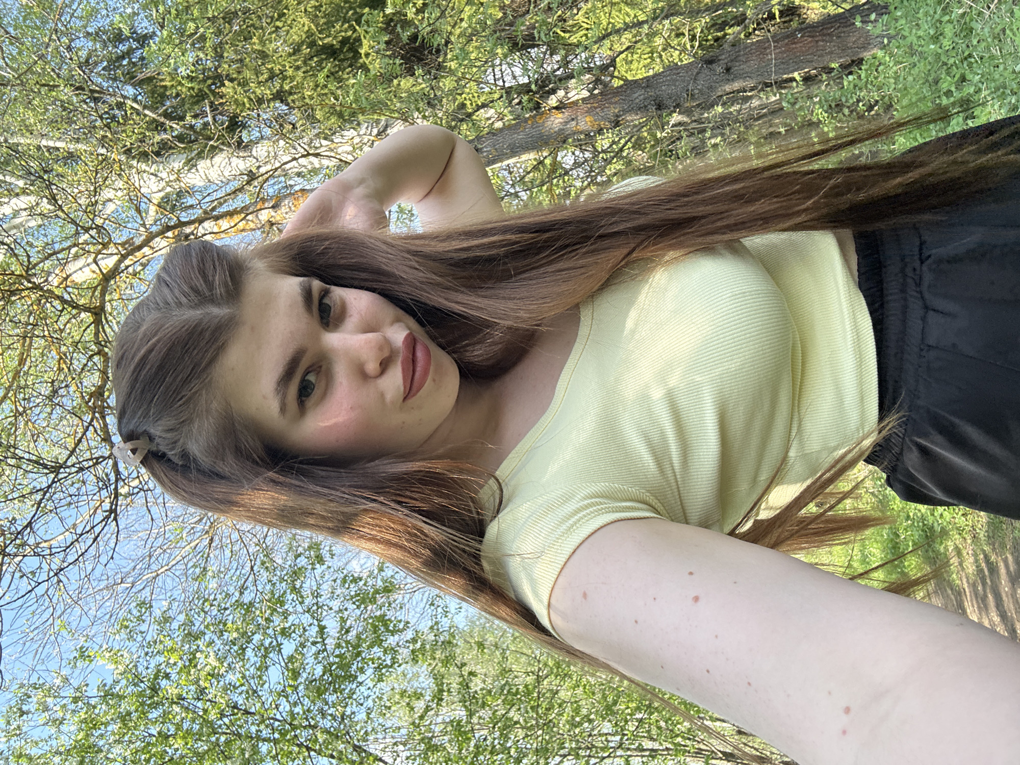 Young woman takes outdoor selfies in Russian woodland setting