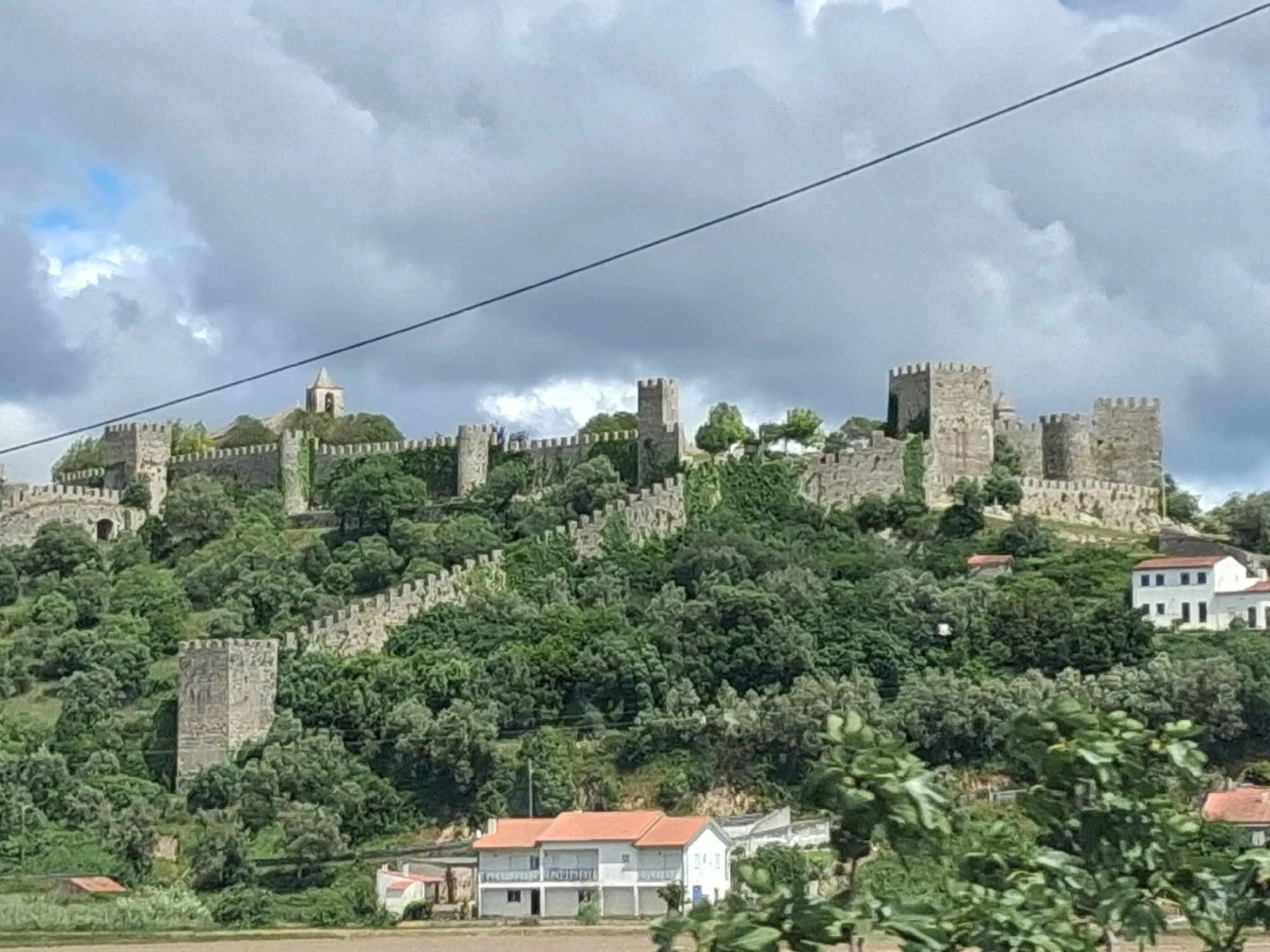 Medieval castle documented on Portuguese hilltop amid green vegetation