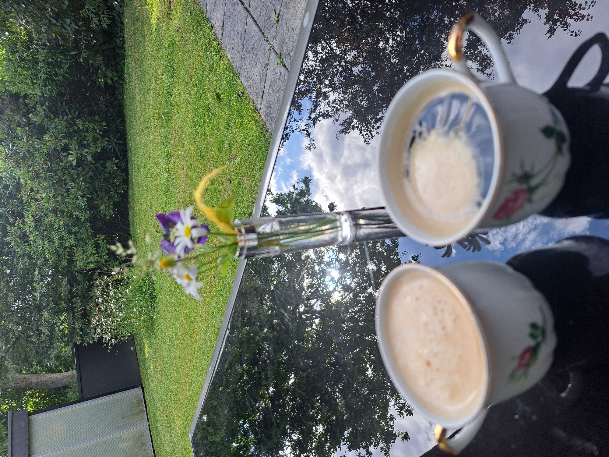 Garden coffee break with potted flowers and patio plants