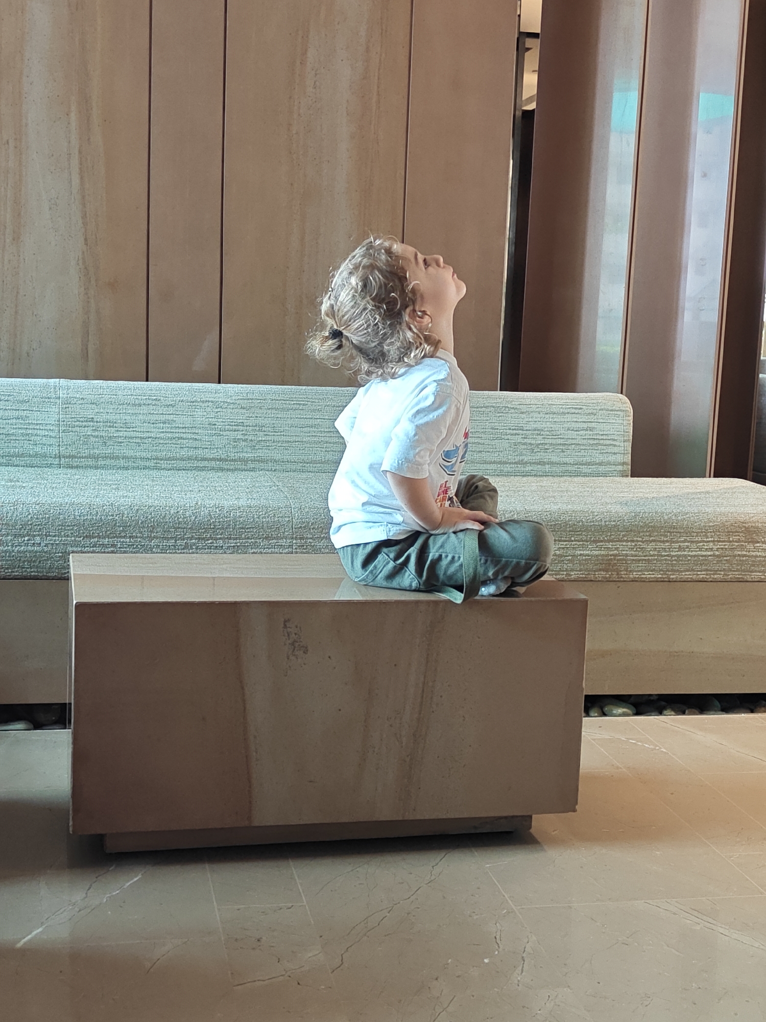 Perched on a stone block, looking up mid-expression in Mumbai
