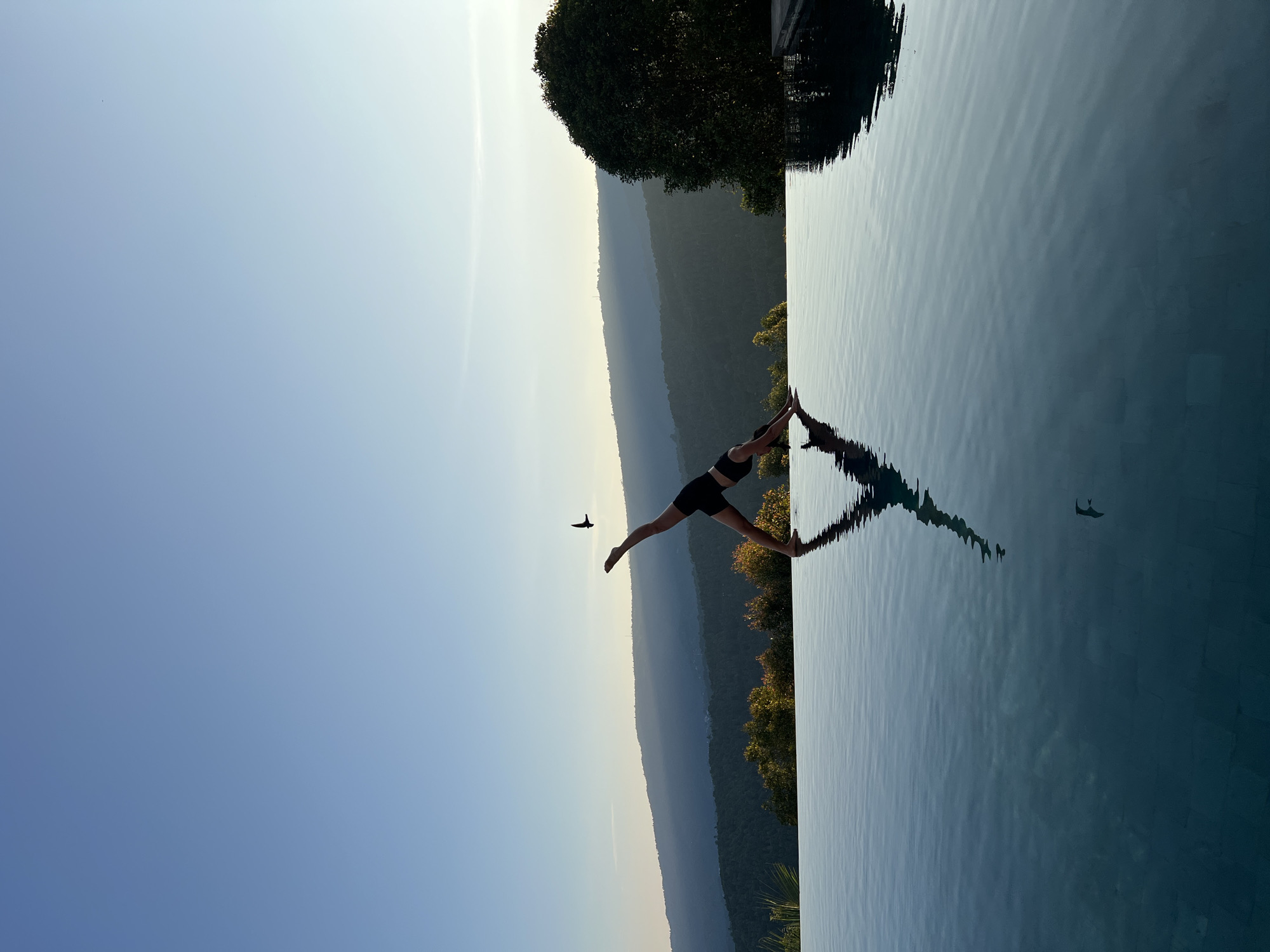 Sunset yoga session at Indonesian infinity pool resort