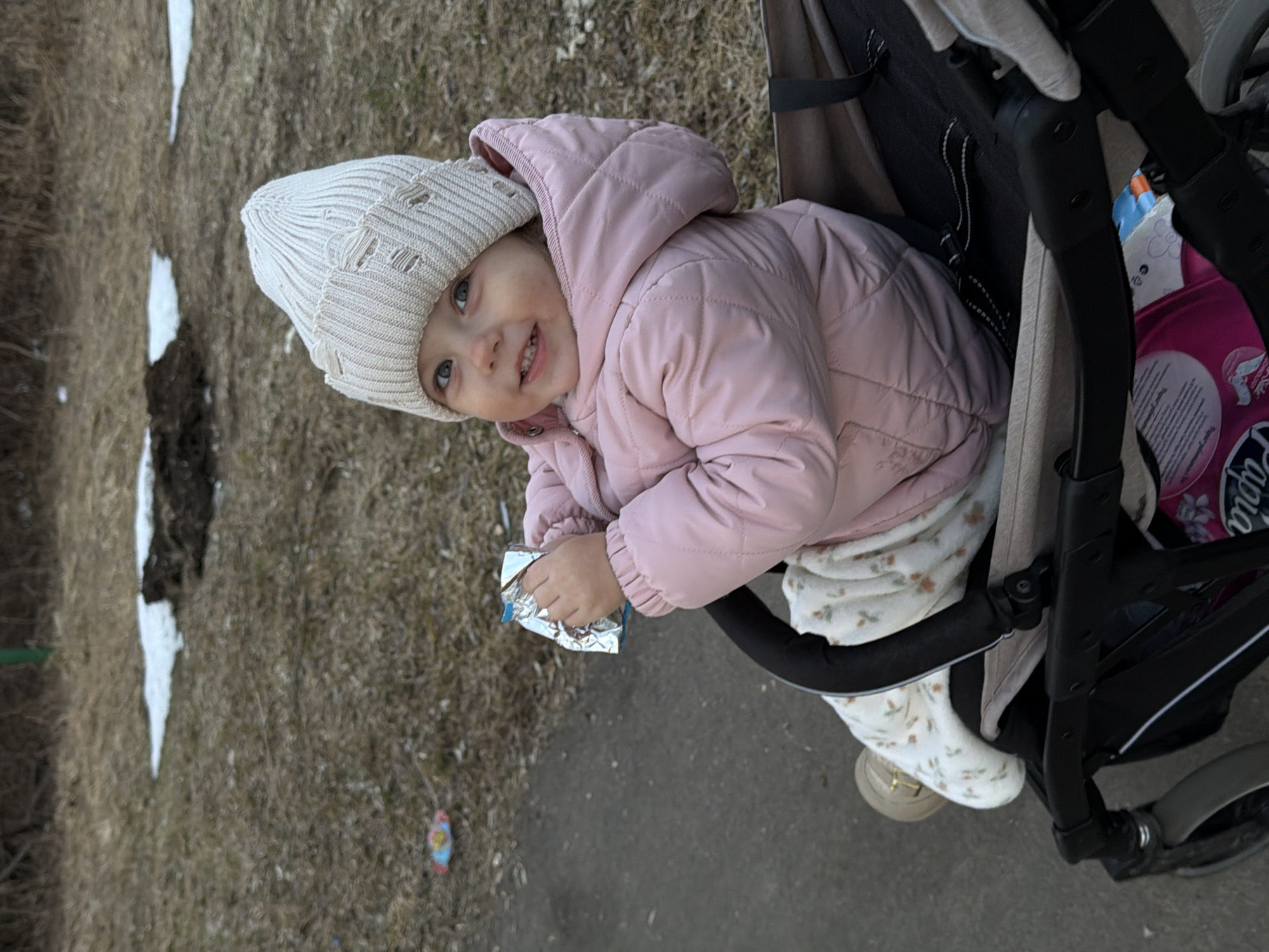 Woman films self while child plays outdoors in Reshetnikovo