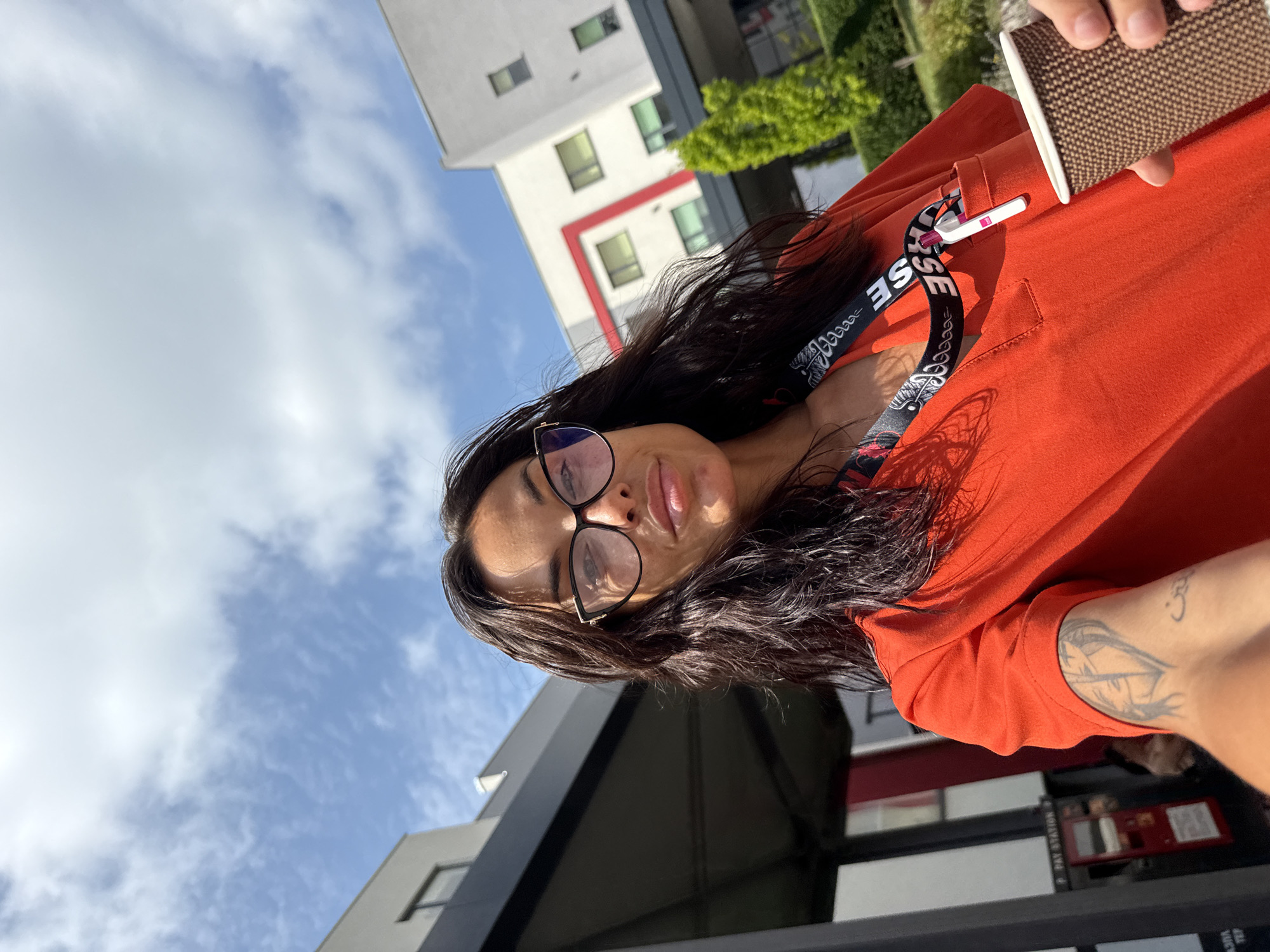 Morning coffee stop in Pleven, lanyard and orange top