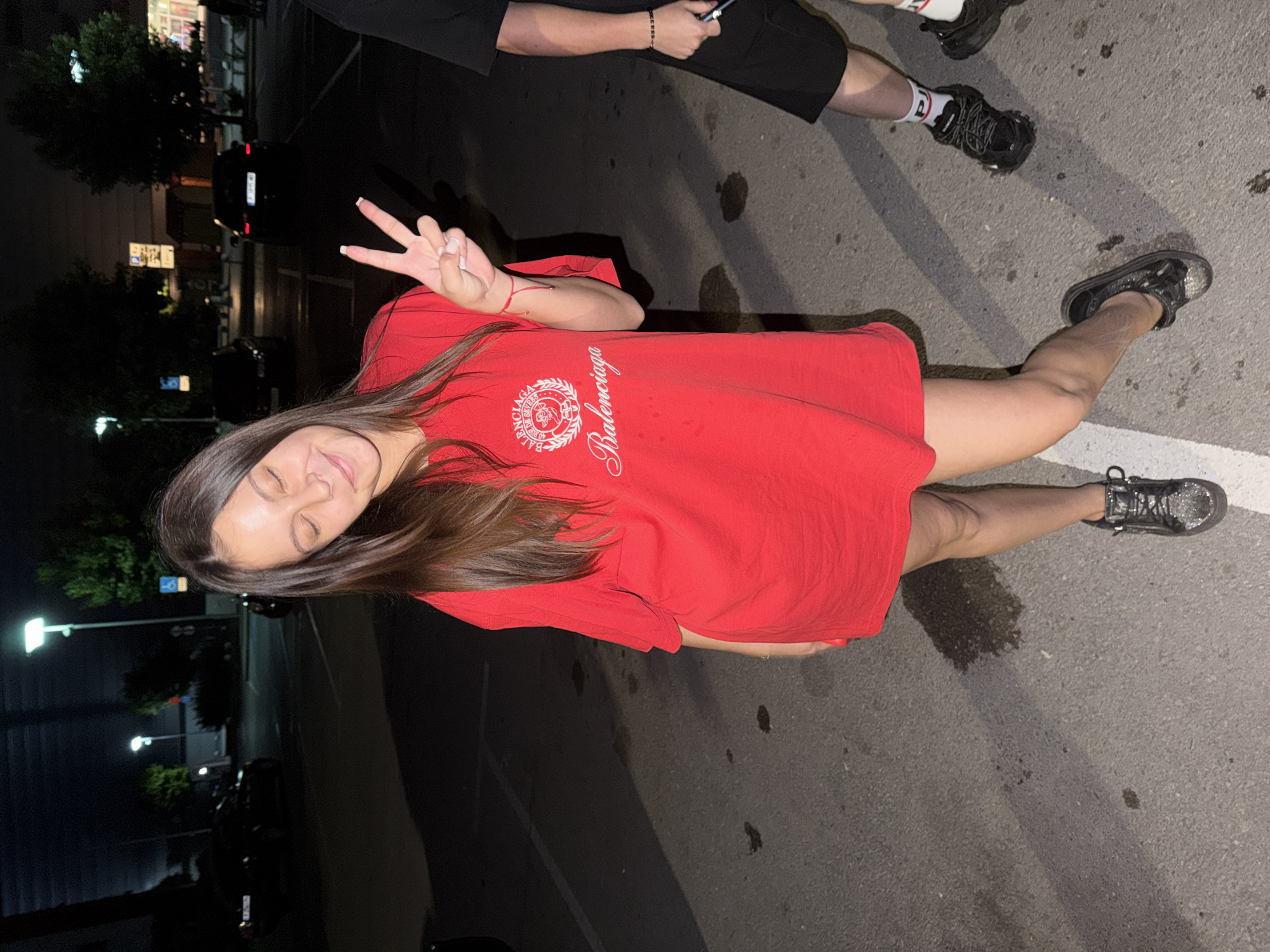 Woman poses in parking lot during nighttime photo session