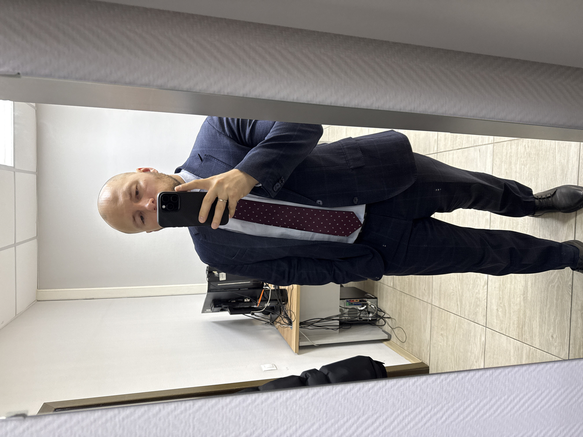 Man takes office mirror selfie in Krasnoyarsk workspace