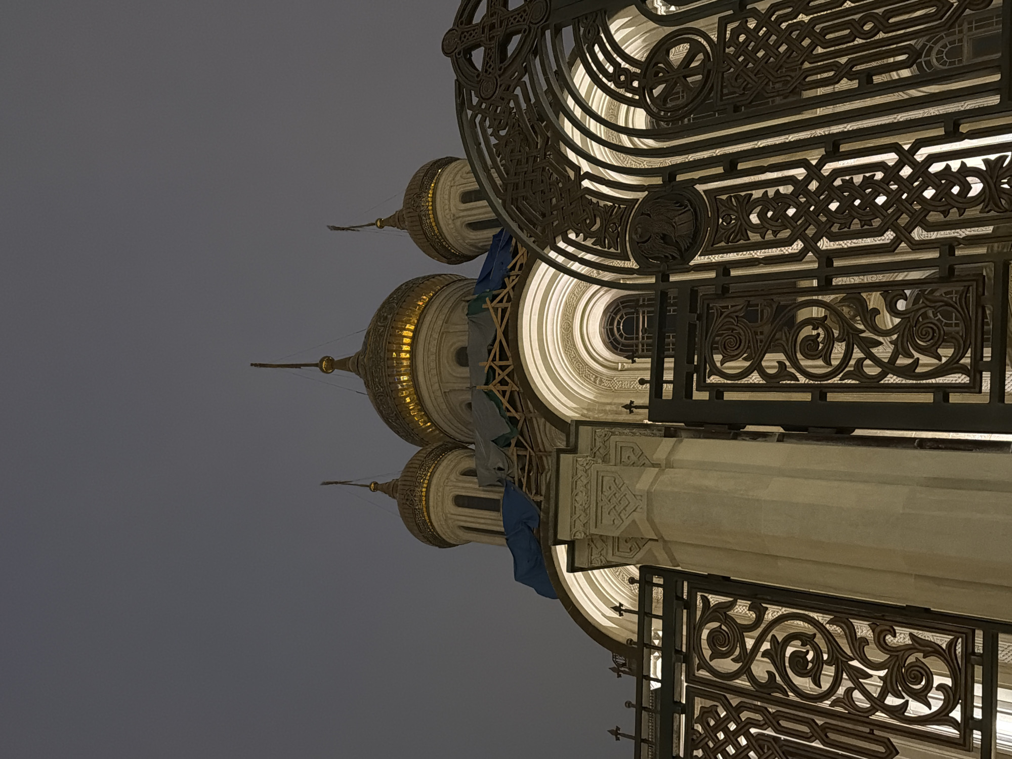 Orthodox church with golden domes illuminated at night in Moscow