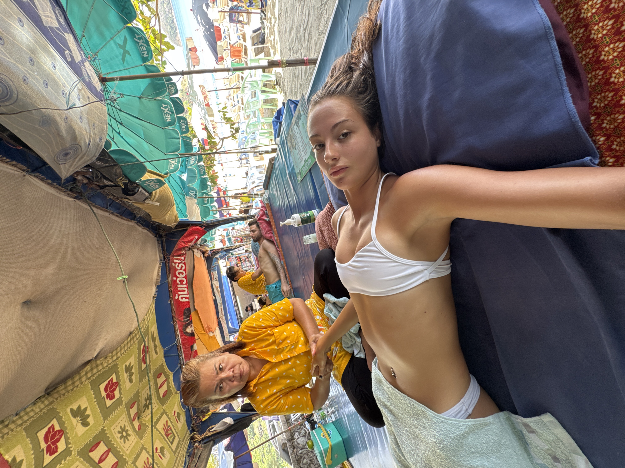 Tourist documents beachside massage experience in Rawai Thailand