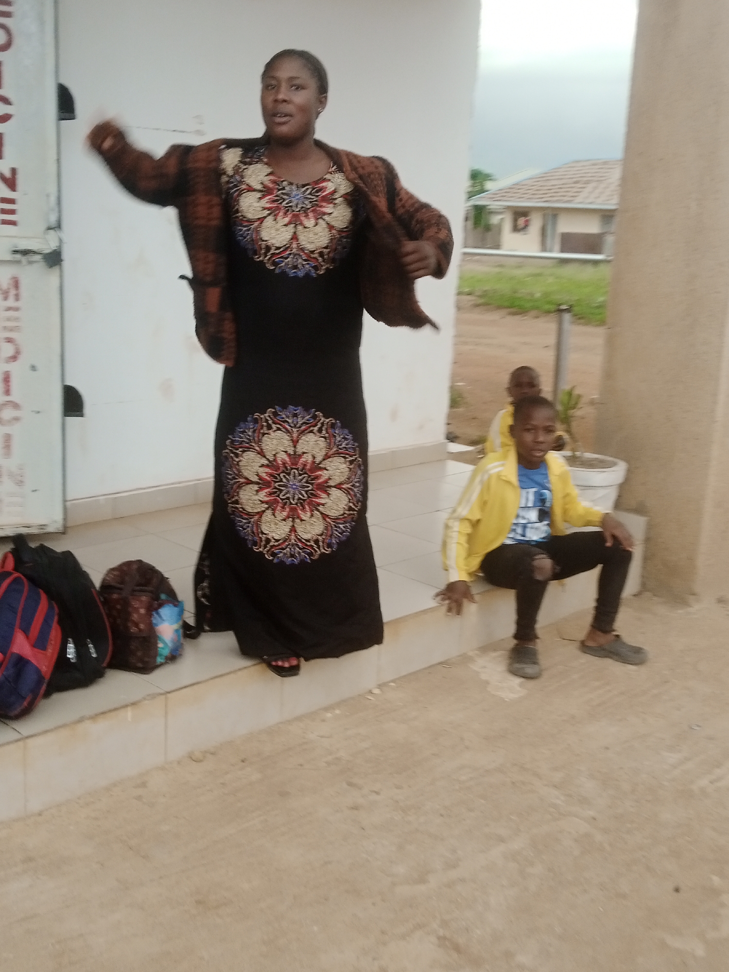 Gathering outside a building in Katon Rikkos, Nigeria