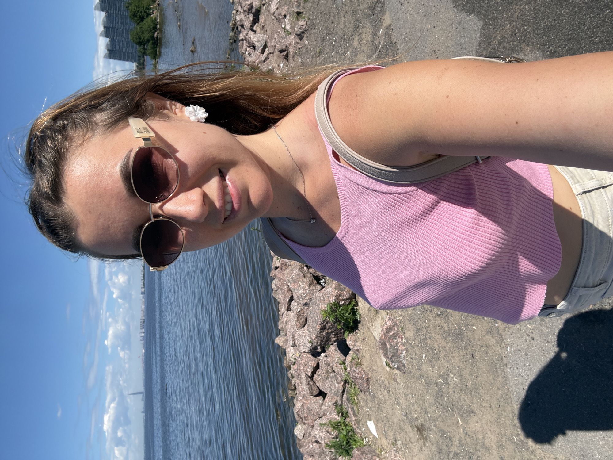 Waterfront bike stop, selfies, and a calm bay on a sunny morning