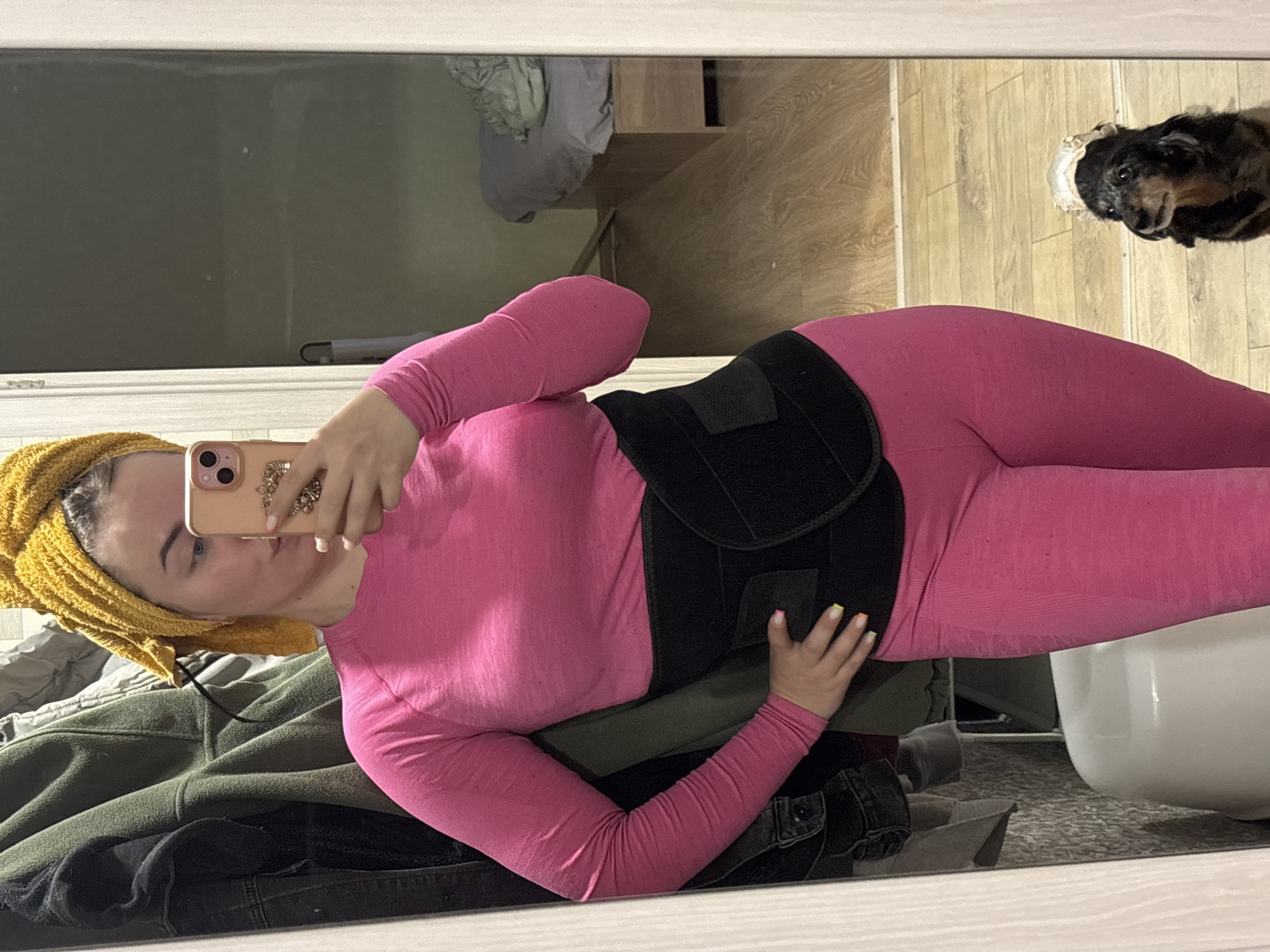 Person takes mirror selfie in pink athletic wear, Izhevsk
