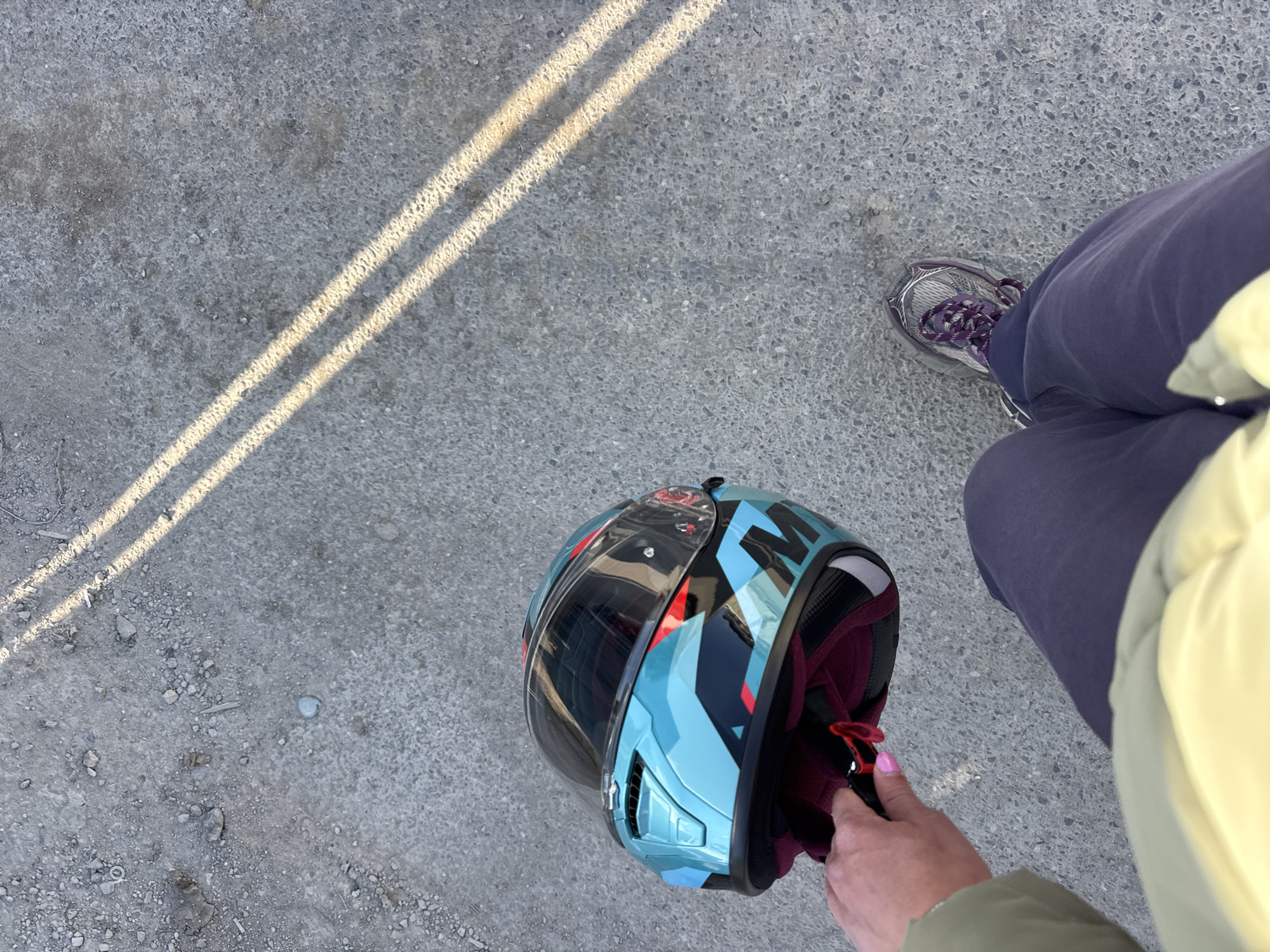 Person with motorcycle helmet observed on concrete surface in Sofia