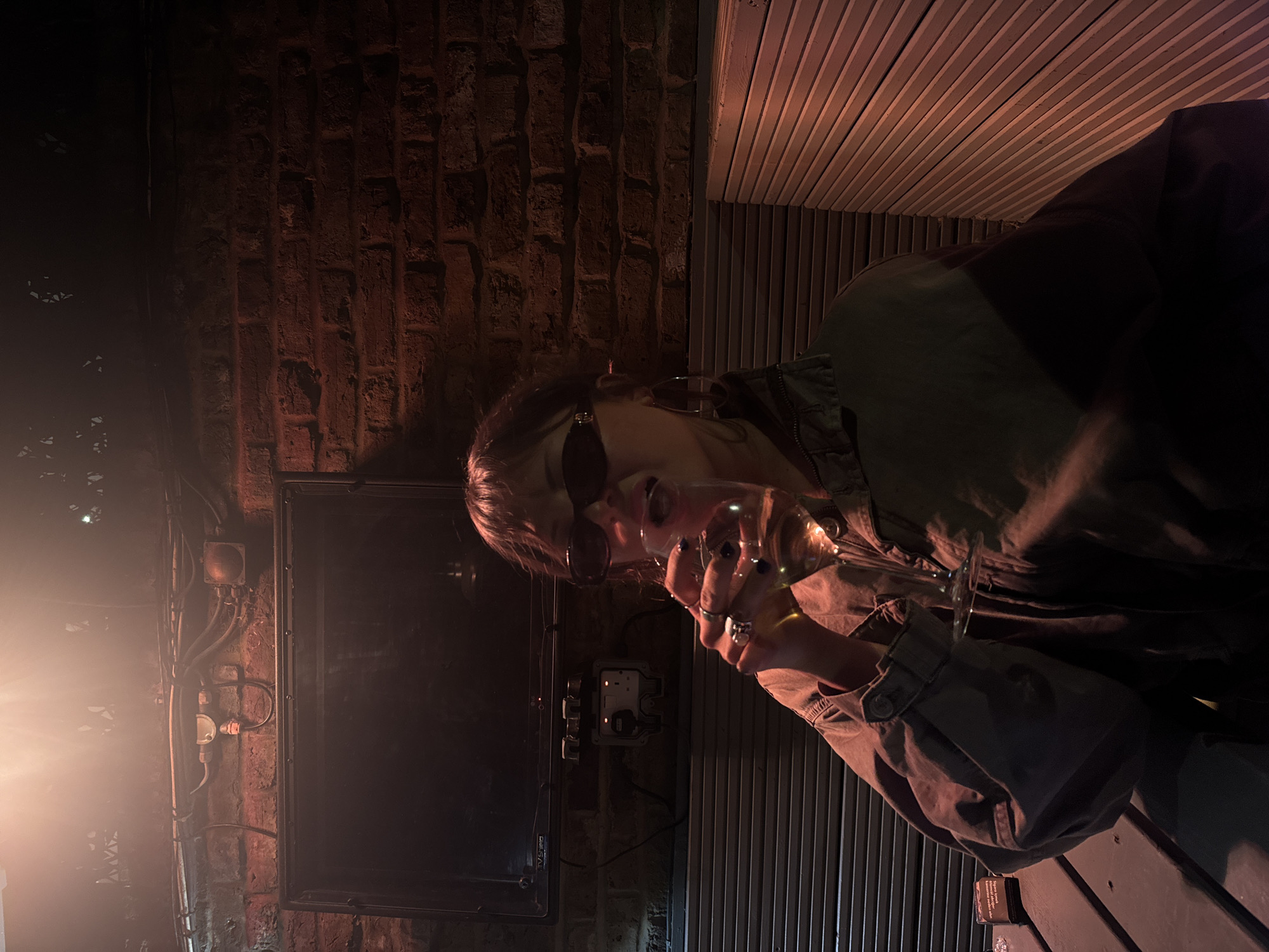 Person with drink captured in dimly lit London scene