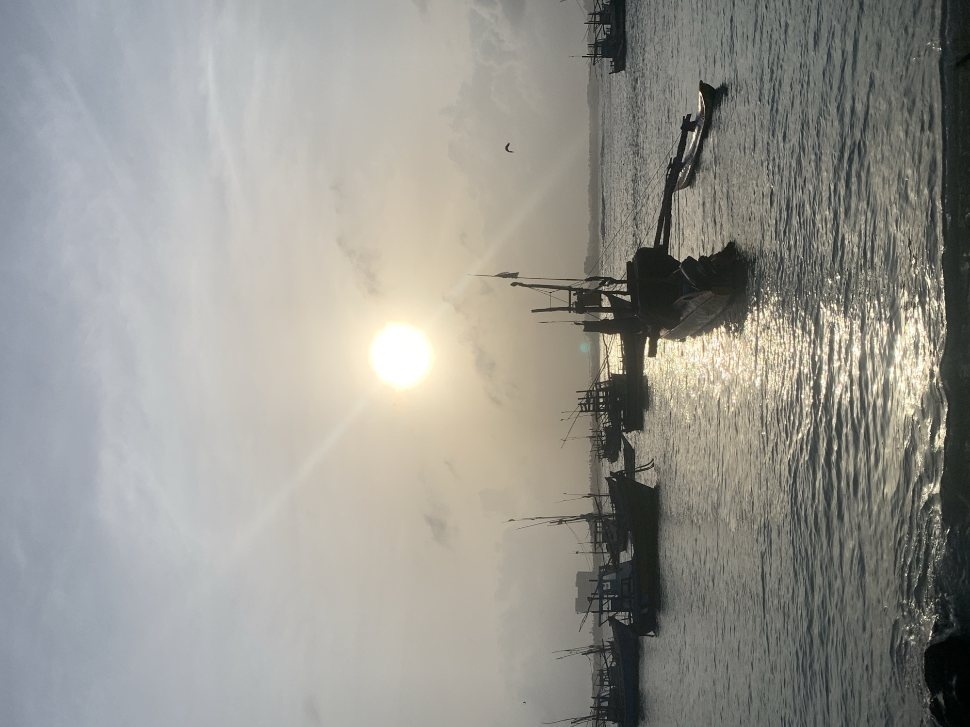 Fishing boats anchored off the hazy coast of Midigama