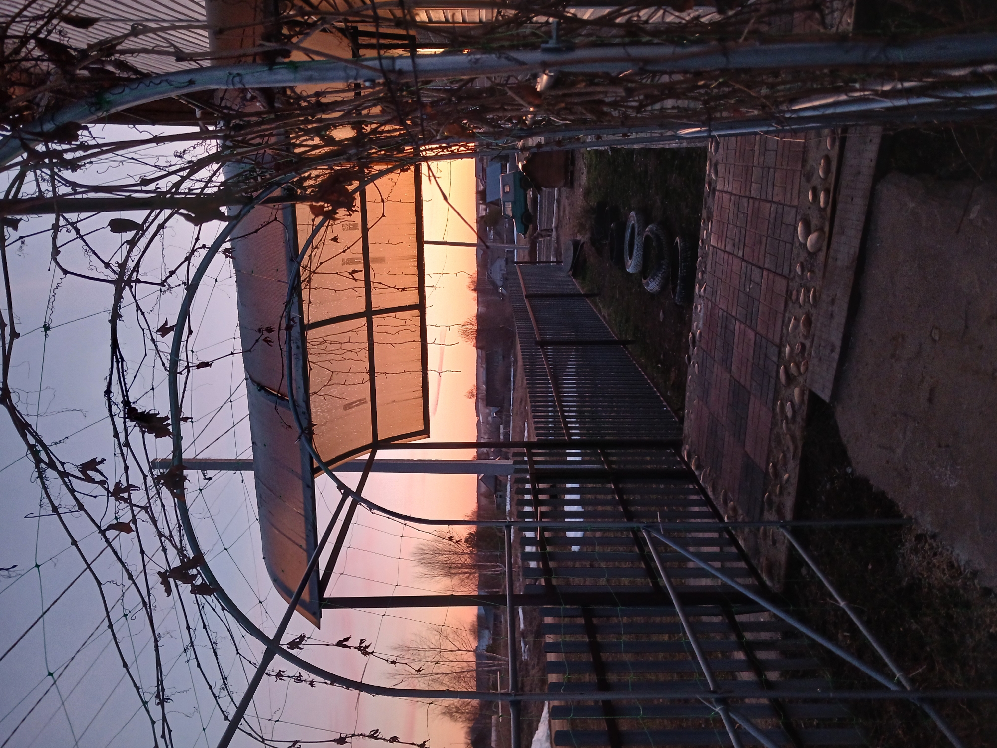 Sunset moments captured through archway in Bolshaya Sosnova, Russia