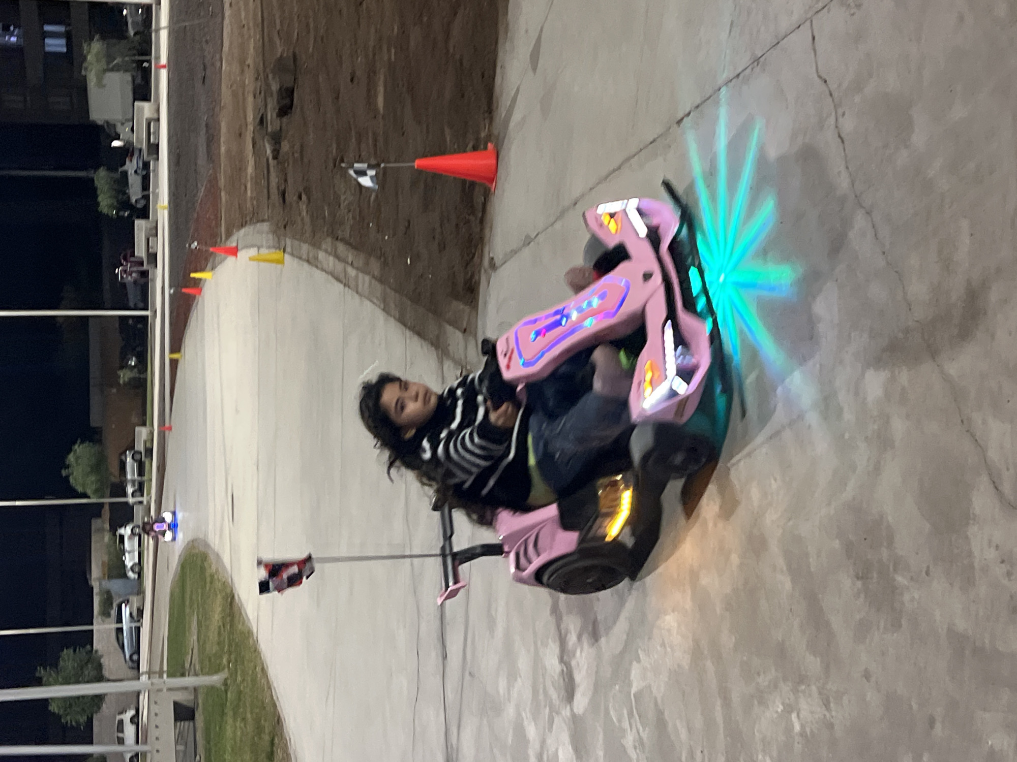 Electric go-karts with LED lights on a night track in Arica