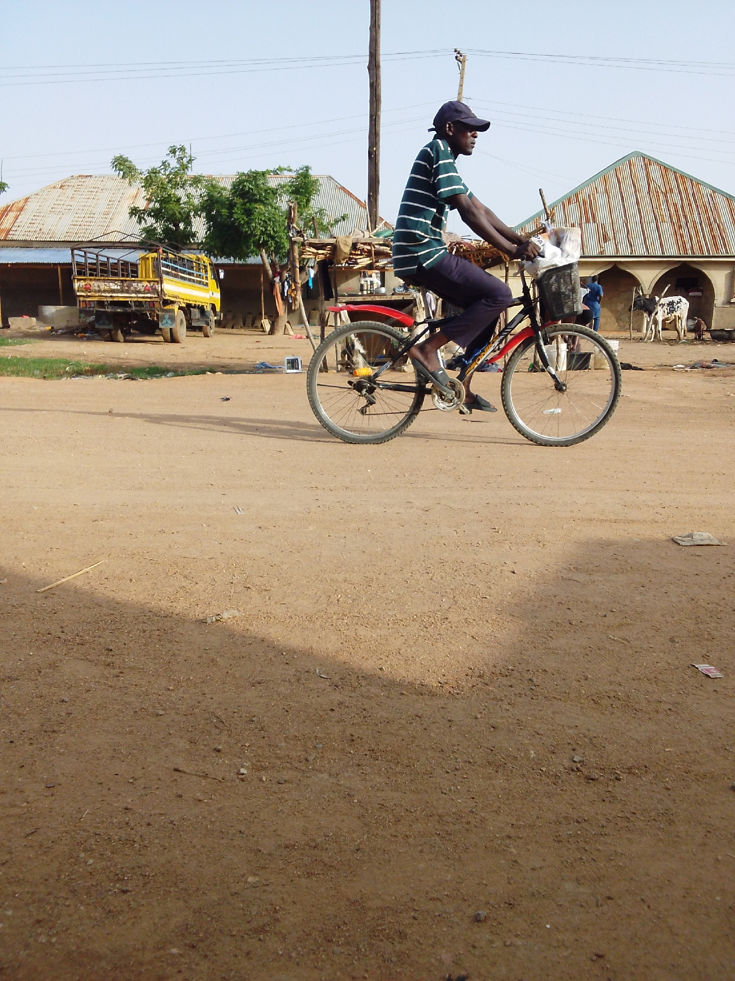 Daily life unfolds on dirt streets in Bauchi residential area