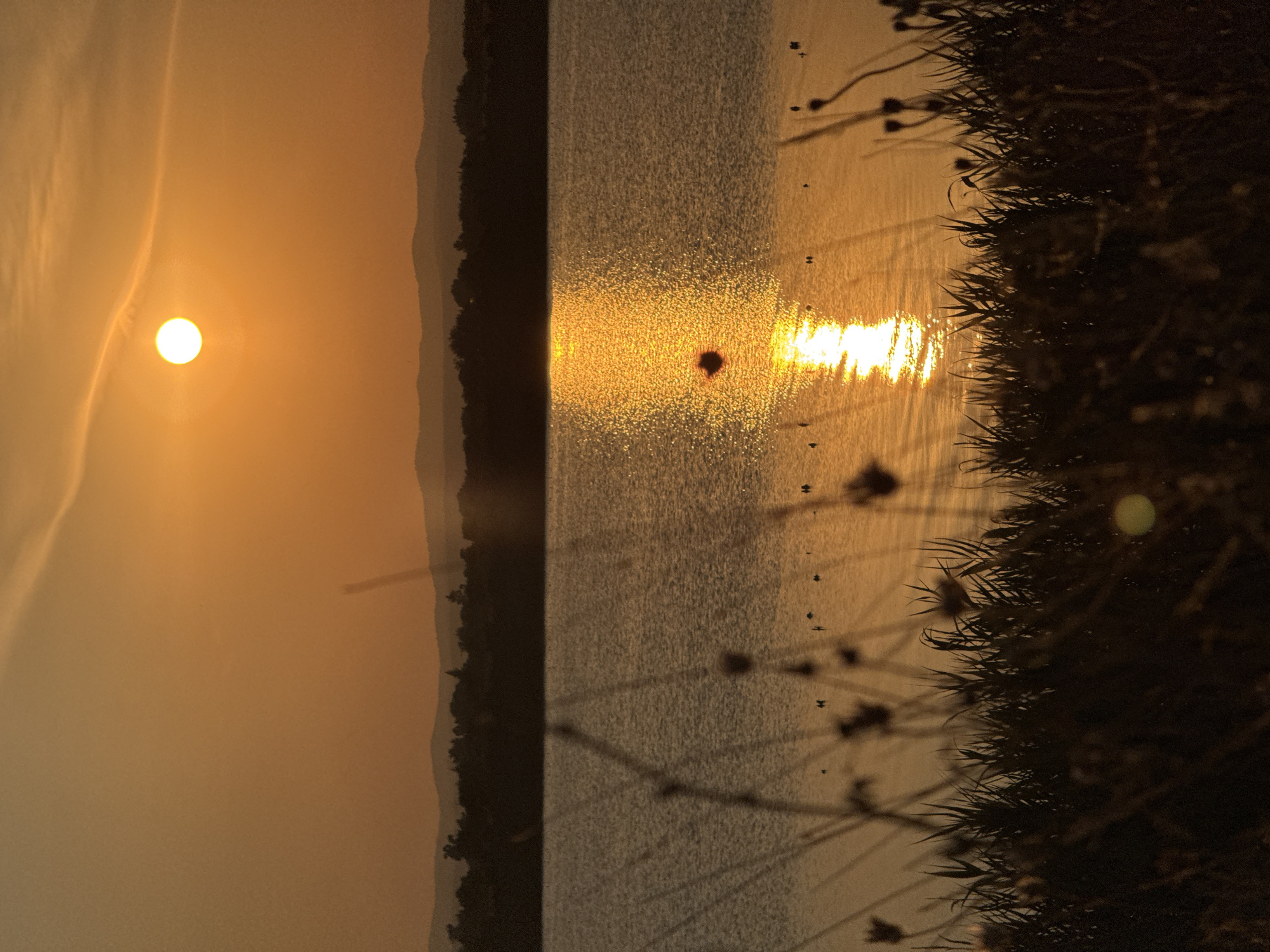 Sunset light over Pomorie's lake and beach shoreline