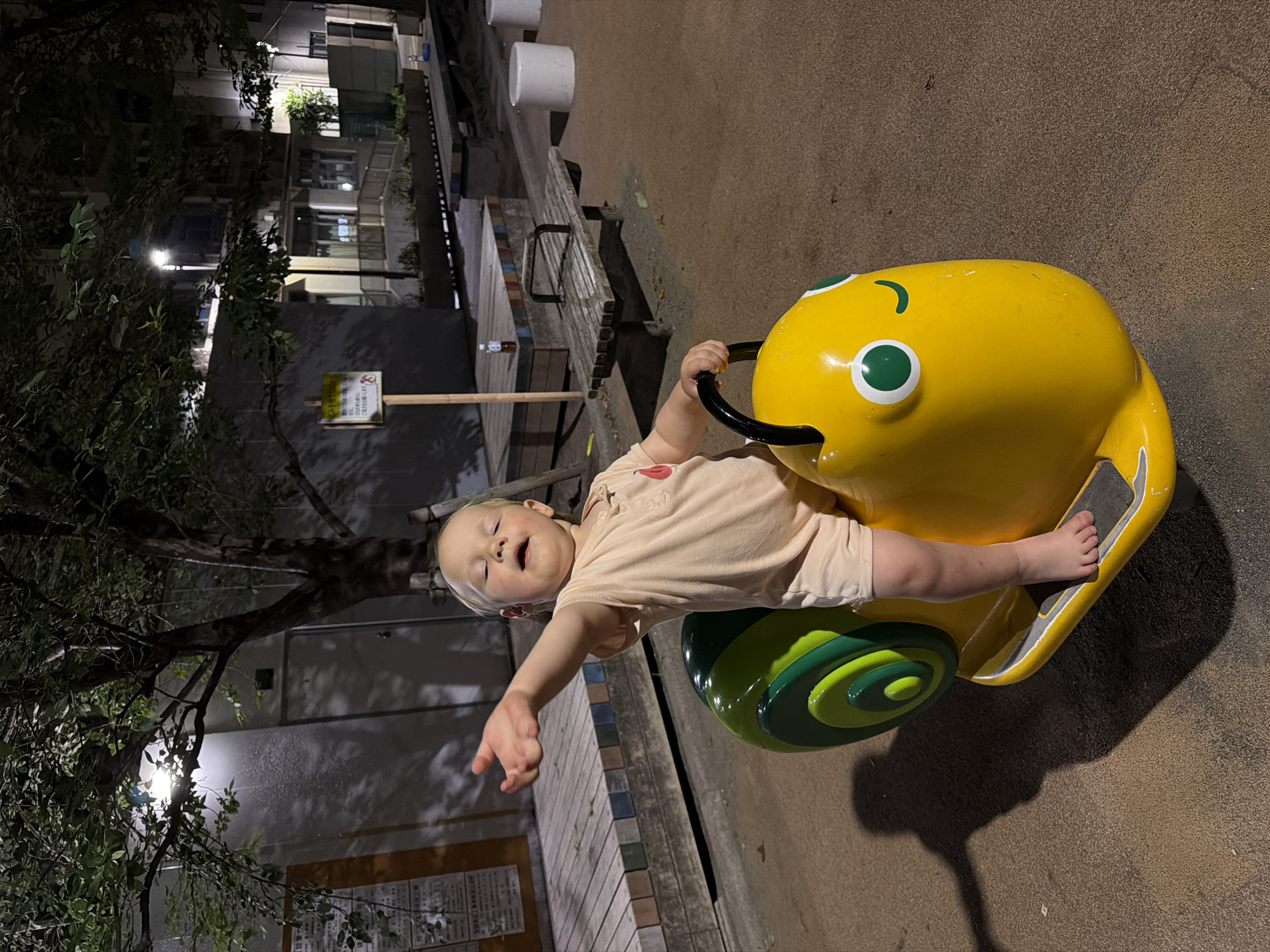 Night playground time on yellow snail rider in Chuo