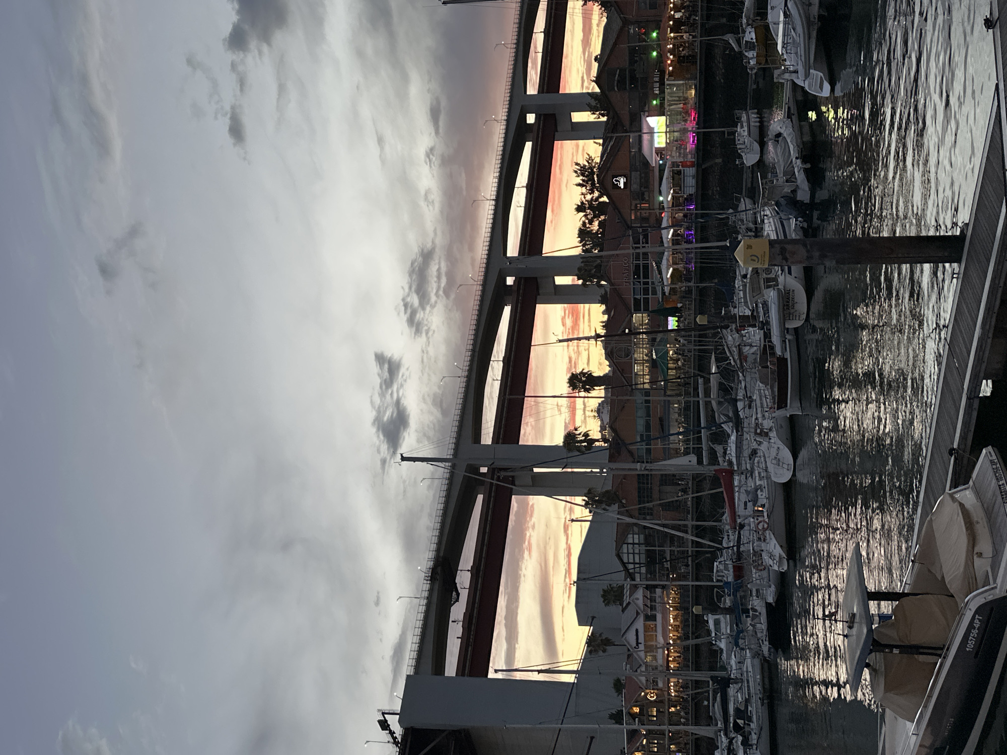 Dusk under Lisbon's bridge, plane passing overhead