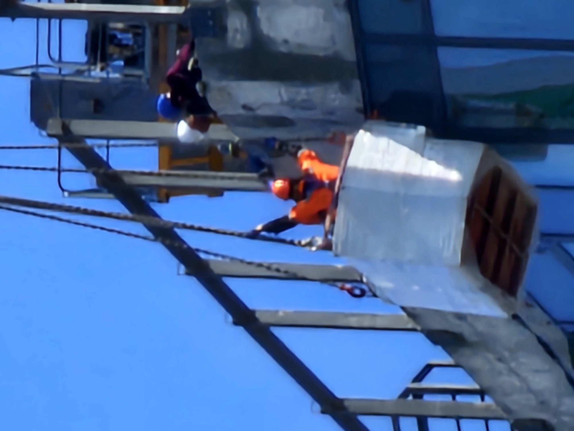 Construction and rope-access maintenance on a Moscow glass-facade building