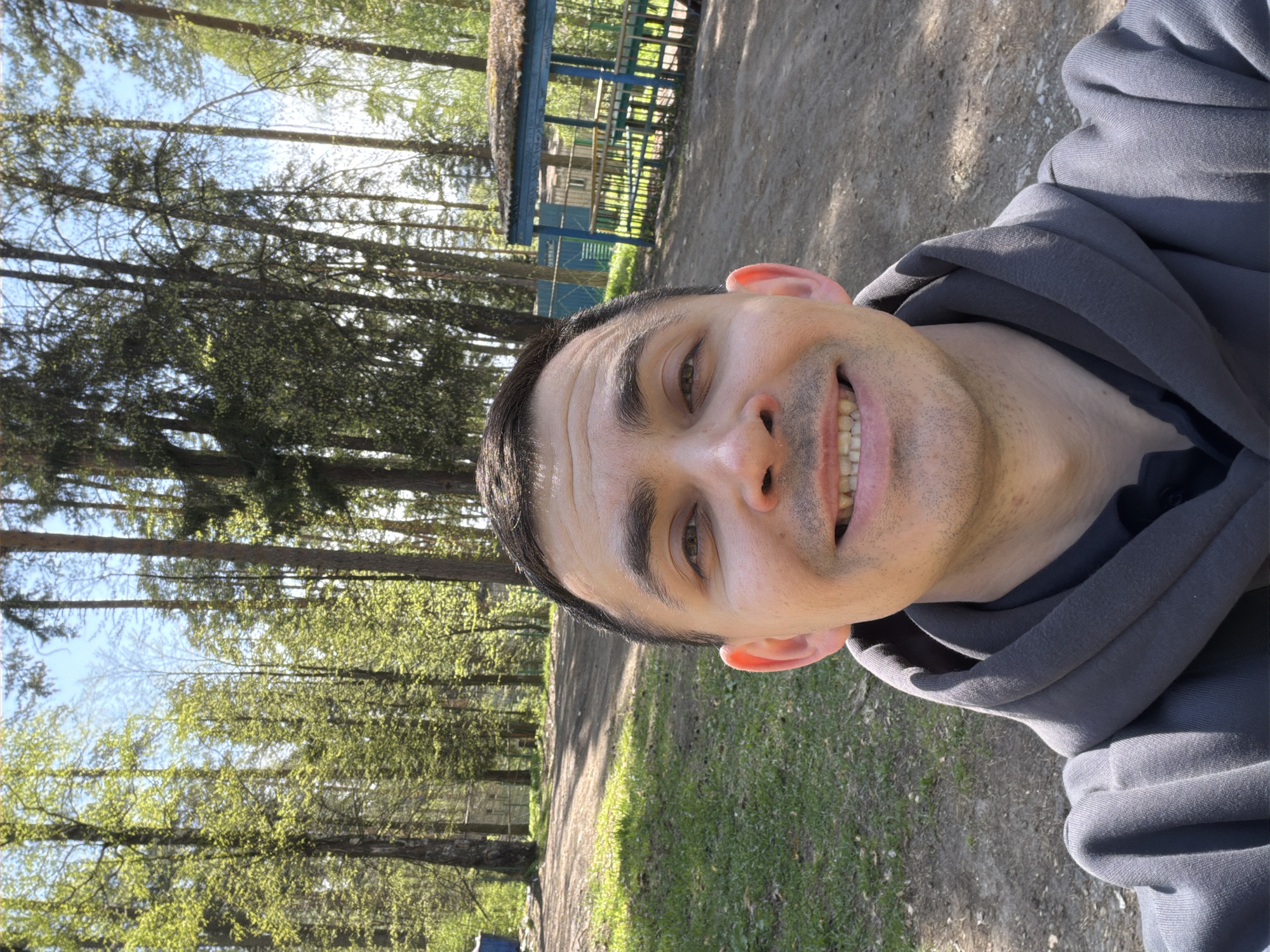 Man photographed smiling on forest path in Izhevsk