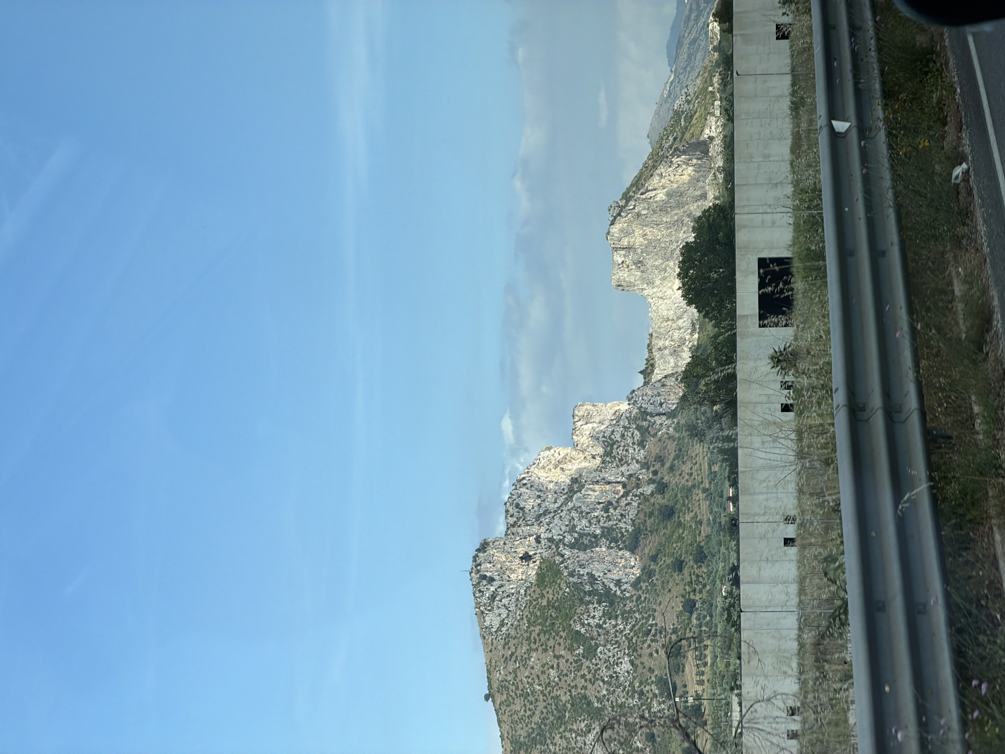 Roadside landscape photographed from moving vehicle in Italy