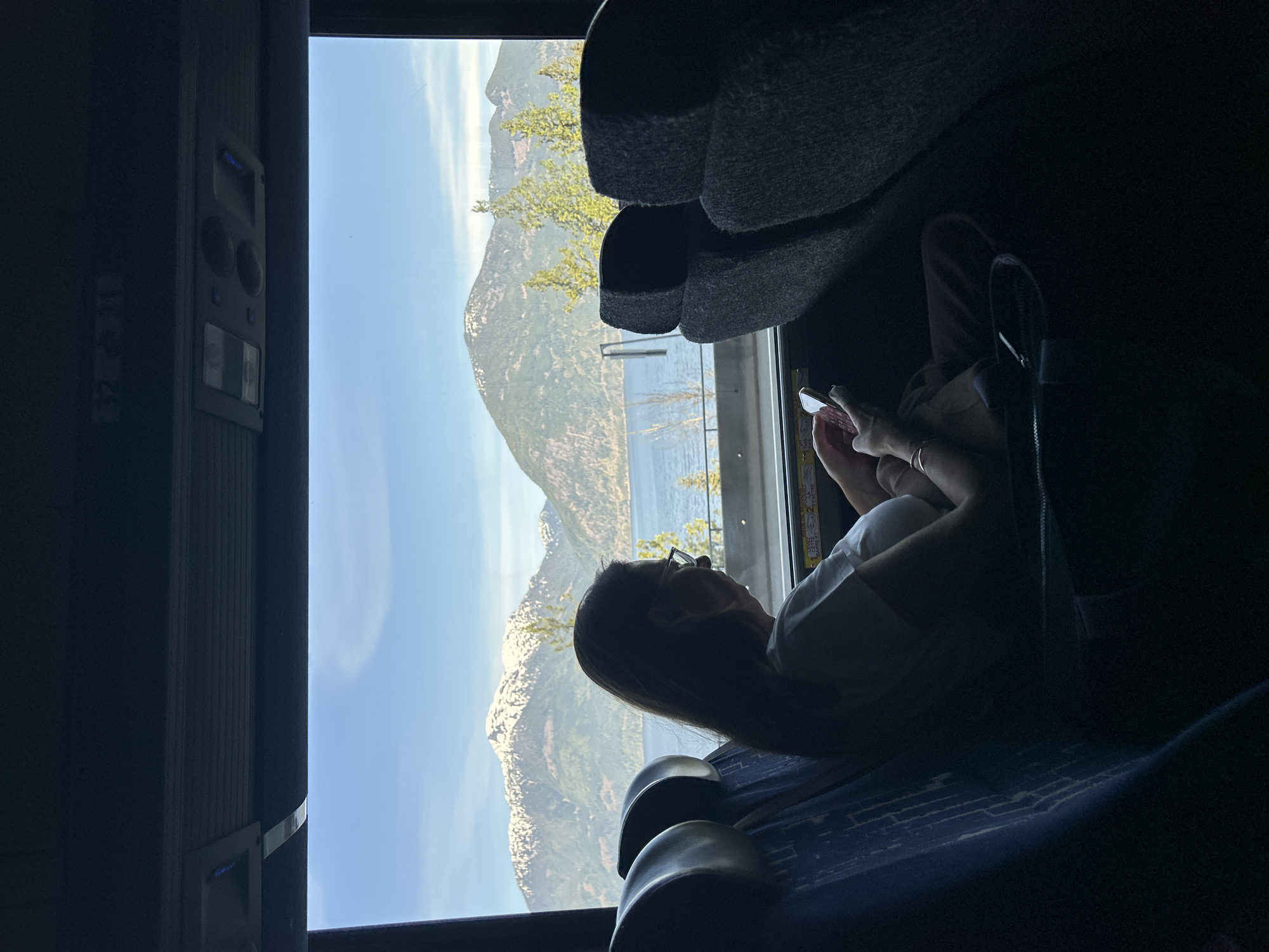 Woman records scenic mountain bus journey on smartphone