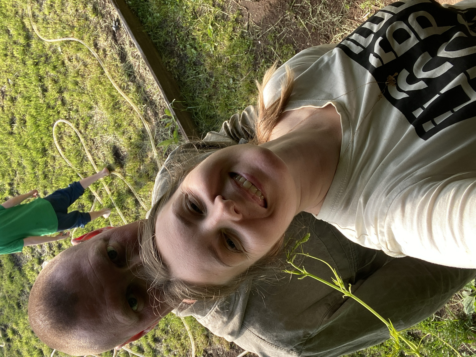 Family enjoys sunny afternoon gardening in Chaikovsky backyard